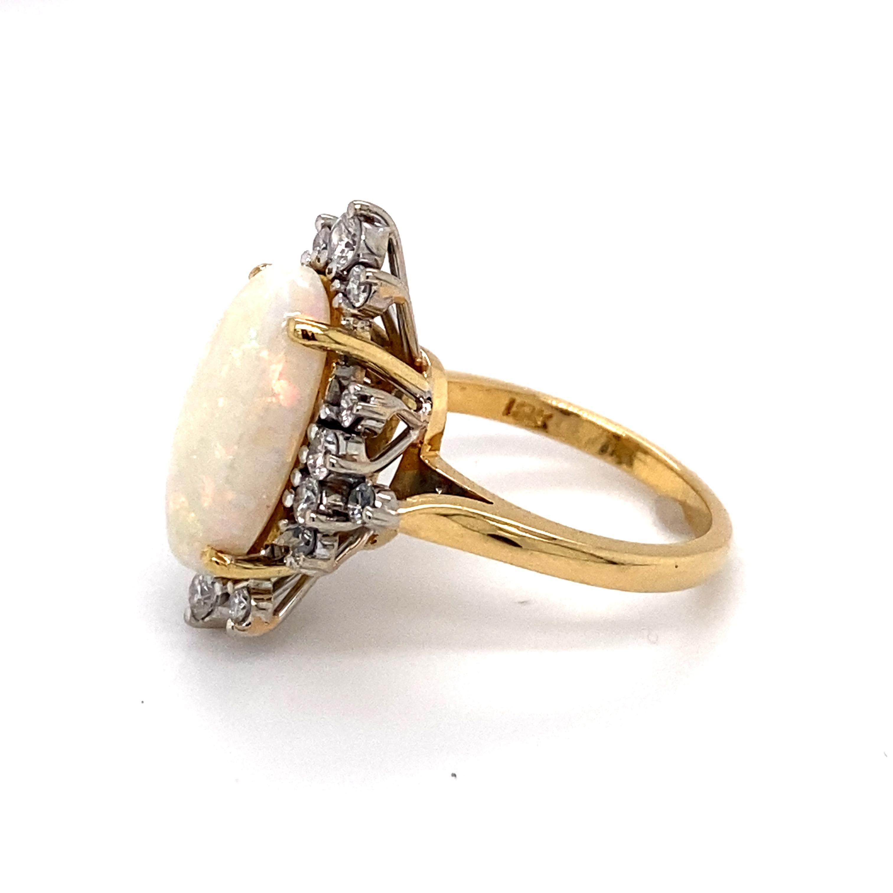 Circa: 1950
Metal Type: 18 Karat Yellow Gold
Weight: 7.7 grams
Size: US 5.5, resizable

Diamond Details:
Carat: 0.50 carat total weight
Shape: Round
Color: G
Clarity: VS

Opal Details:
Carat: 3.0 carats
Shape: Oval
Origin: Ethiopia