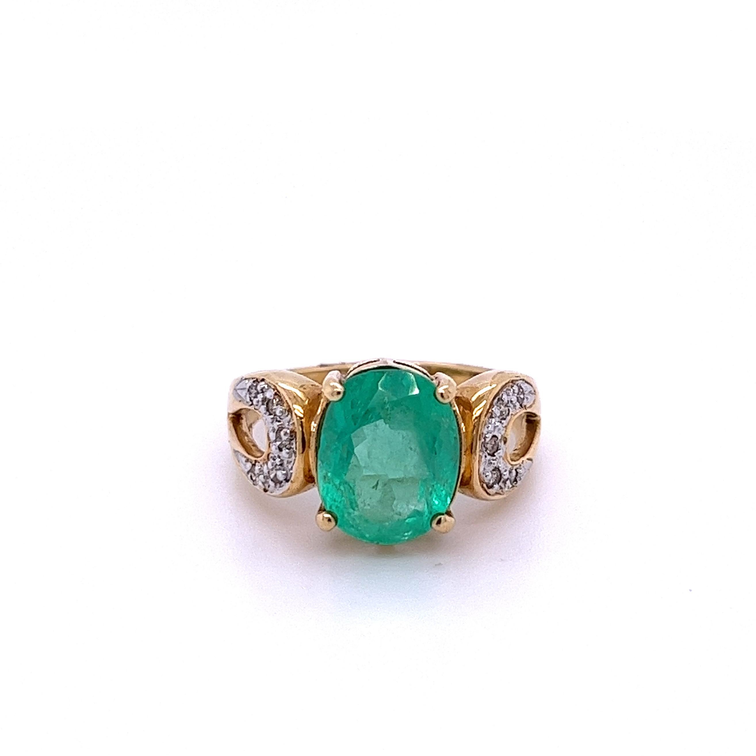 Oval cut natural Colombian Emerald mounted in a secure 14k solid gold ring setting with 0.16 carats in round diamond accents. 14k solid gold ring and secure prong setting make for a secure fit that's ideal for daily wear. Hypoallergenic,