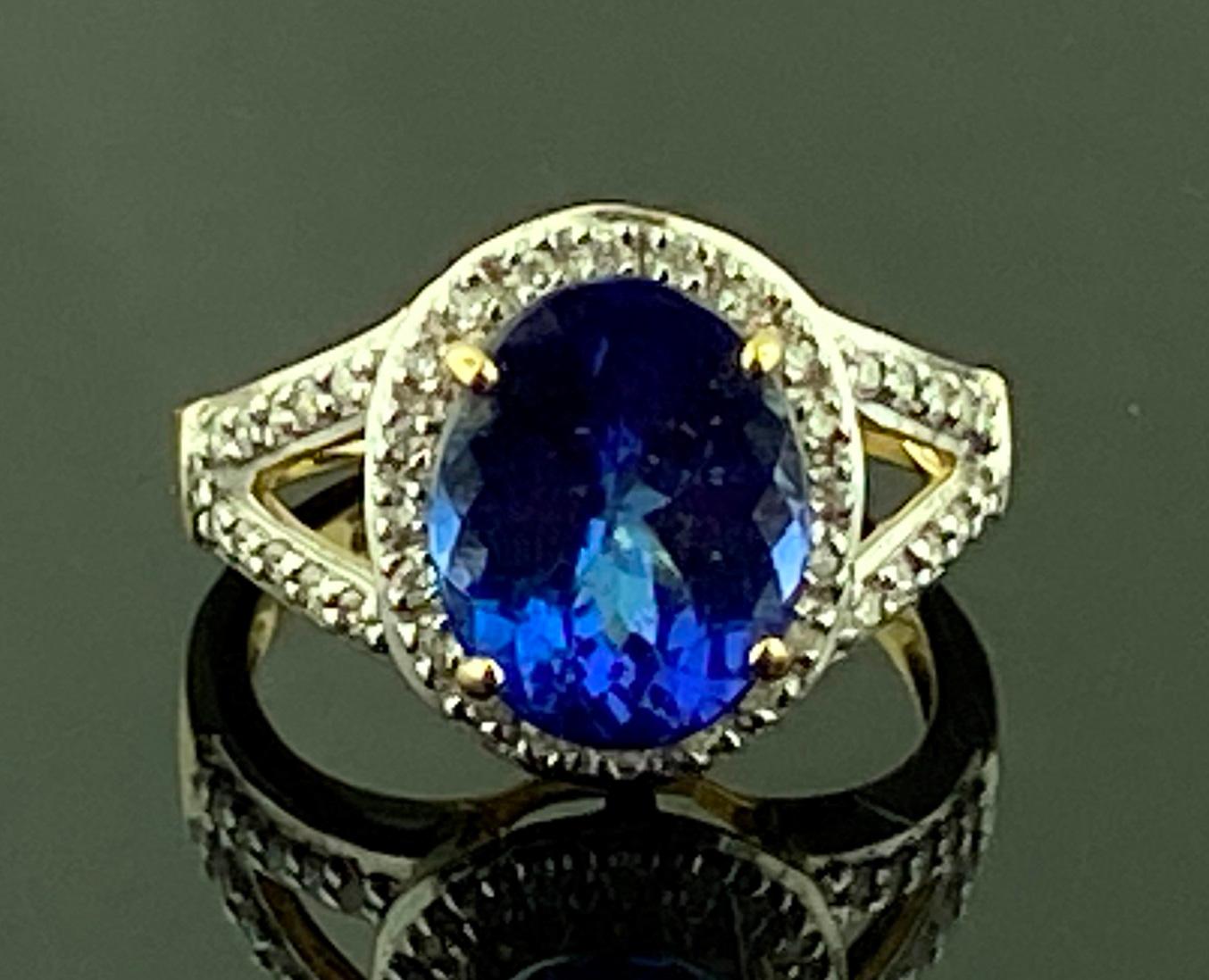 Set in 14 karat yellow gold, weighing 3.72 grams, is one 3.00 carat Oval Cut Tanzanite with 40 Round Brilliant Cut Diamonds weighing approximately 0.20 carats, Color: G-H, Clarity: SI-1.  Ring size is 5.