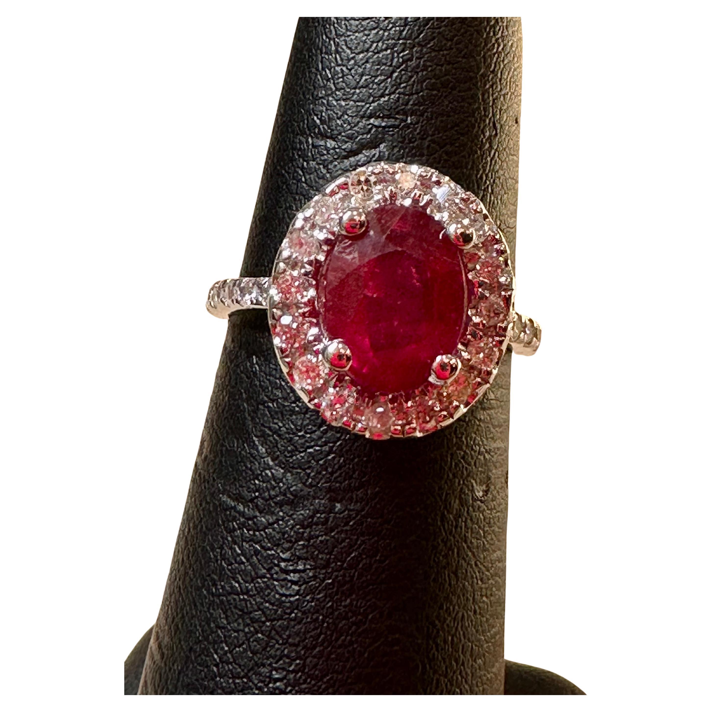 Introducing a truly stunning piece, behold the 3 Carat Oval Treated Ruby & 1.25 ct Diamond Ring in exquisite 14 Karat White Gold. This ring boasts a magnificent Treated Ruby meticulously cut to perfection, weighing approximately 3 carats.