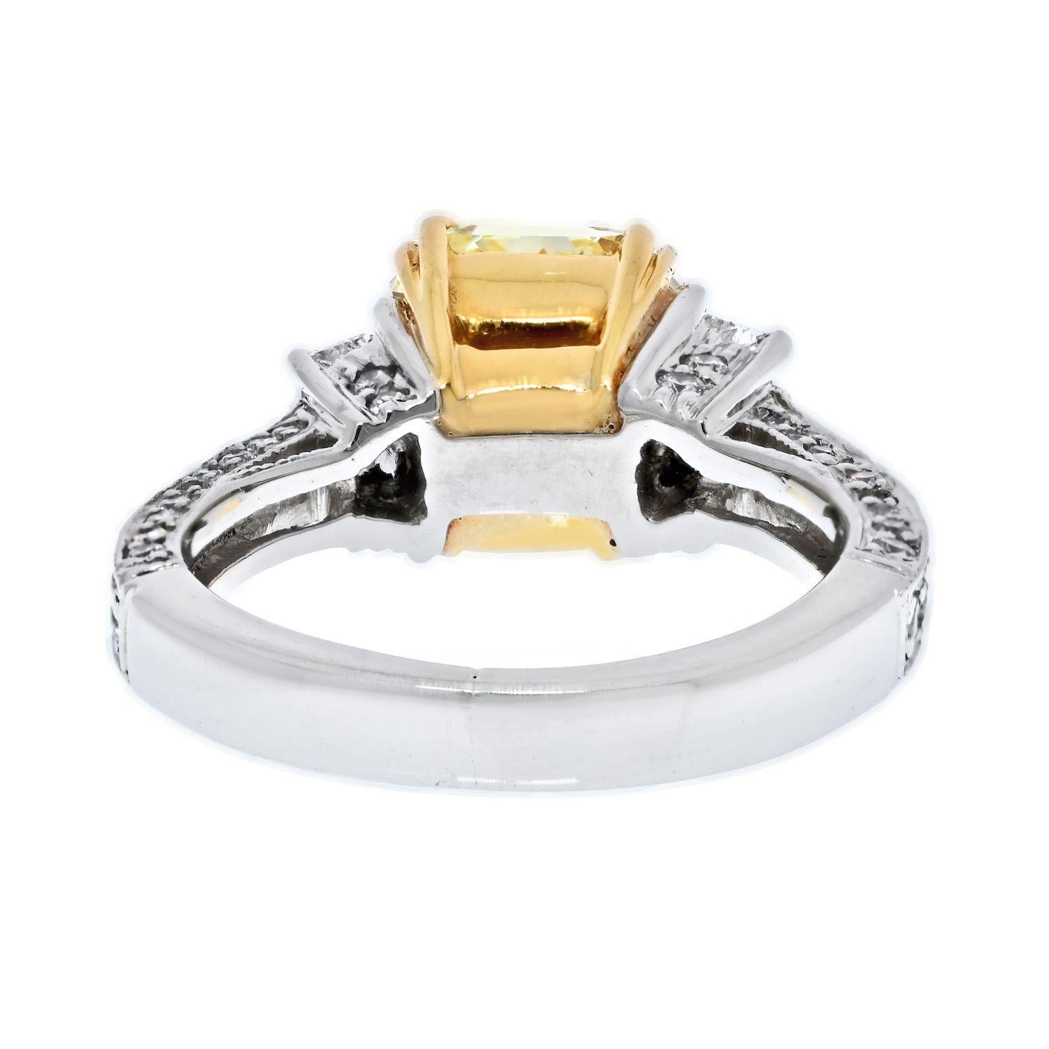 This beautiful ring is designed with a Fancy Yellow radiant cut diamond, flanked by brilliant cut trapezoids, and further decorated with round cut diamonds on all the sides of the shank. The center stone is mounted in 22k yellow gold, while the rest