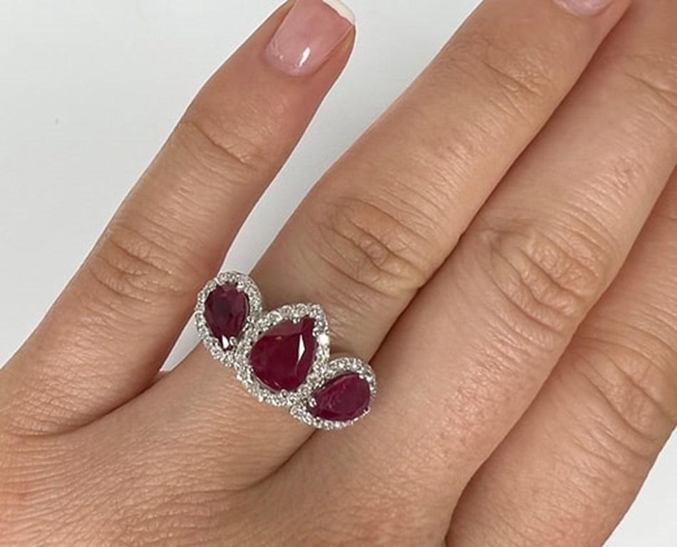 Pear Cut 3 Carat Ruby Three Stone Halo Ring For Sale