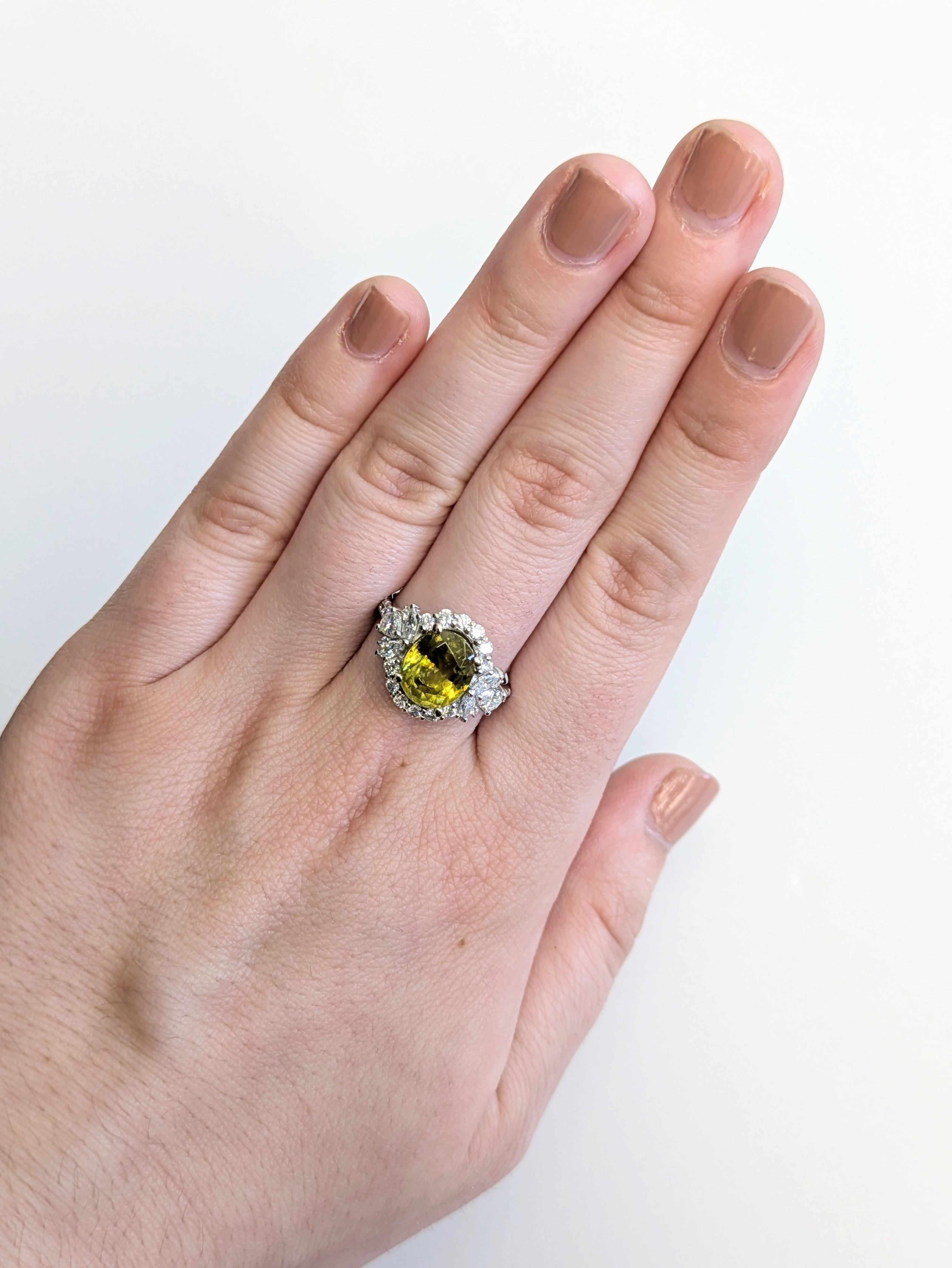 This mesmerizing 3.12 carat oval sphene ring dazzles with vibrant rainbow flashes and is perfectly accented by natural earth-mined diamonds. Set in solid 14k gold, this statement ring is a rare and radiant treasure for those who love standout