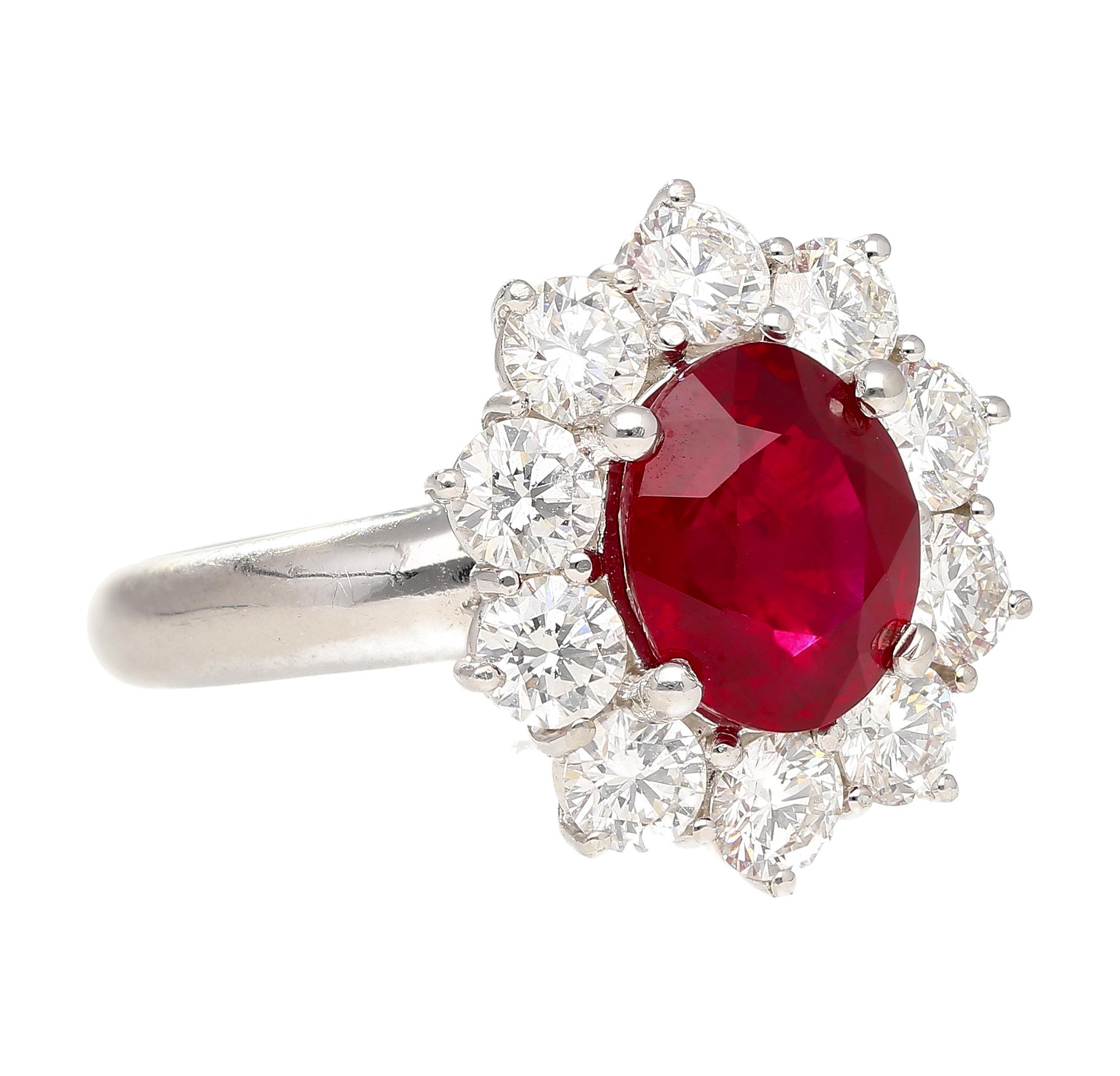 GRS certified 3 carat oval cut Ruby and Diamond halo ring in 18k white gold and platinum. The Ruby is a certified vivid red Pigeons Blood color. This Burma Ruby exhibits a vivid, pure red hue, with a subtle trace of blue, closely resembling the