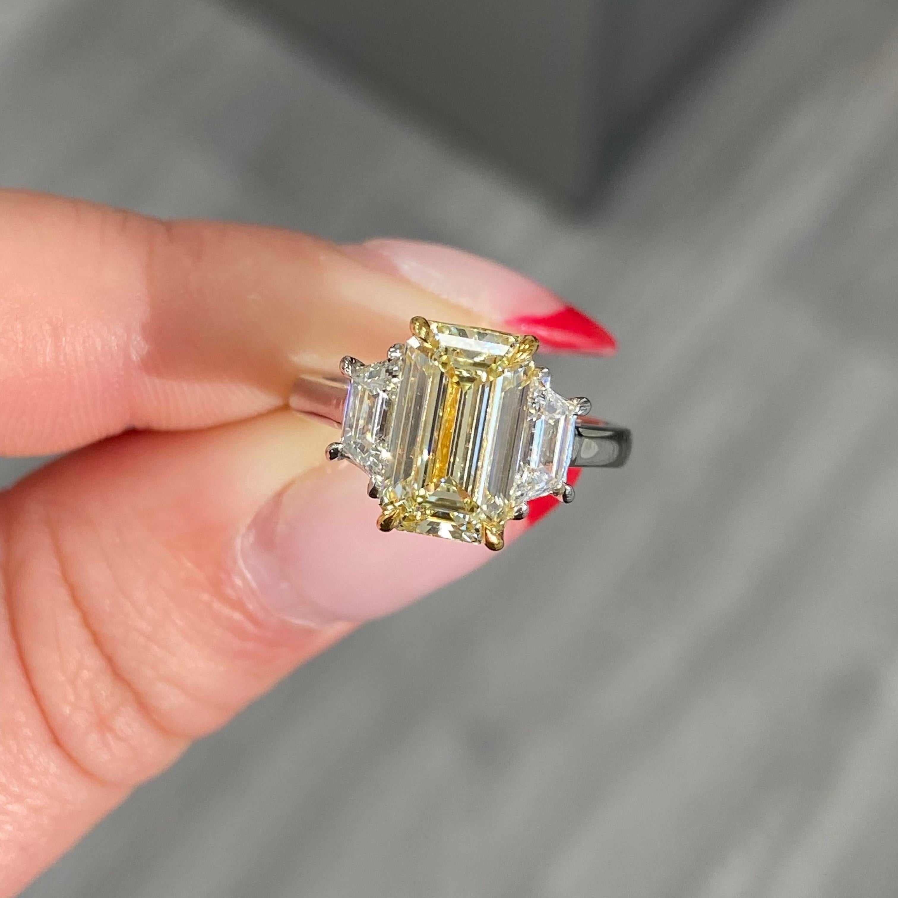 Celebrate love with this exquisite 3-Carat Yellow Emerald Cut Diamond Engagement Ring, a symbol of unparalleled beauty and rarity. At its center is a magnificent 3.01-carat light yellow emerald cut diamond, certified by the GIA. Emerald cut diamonds