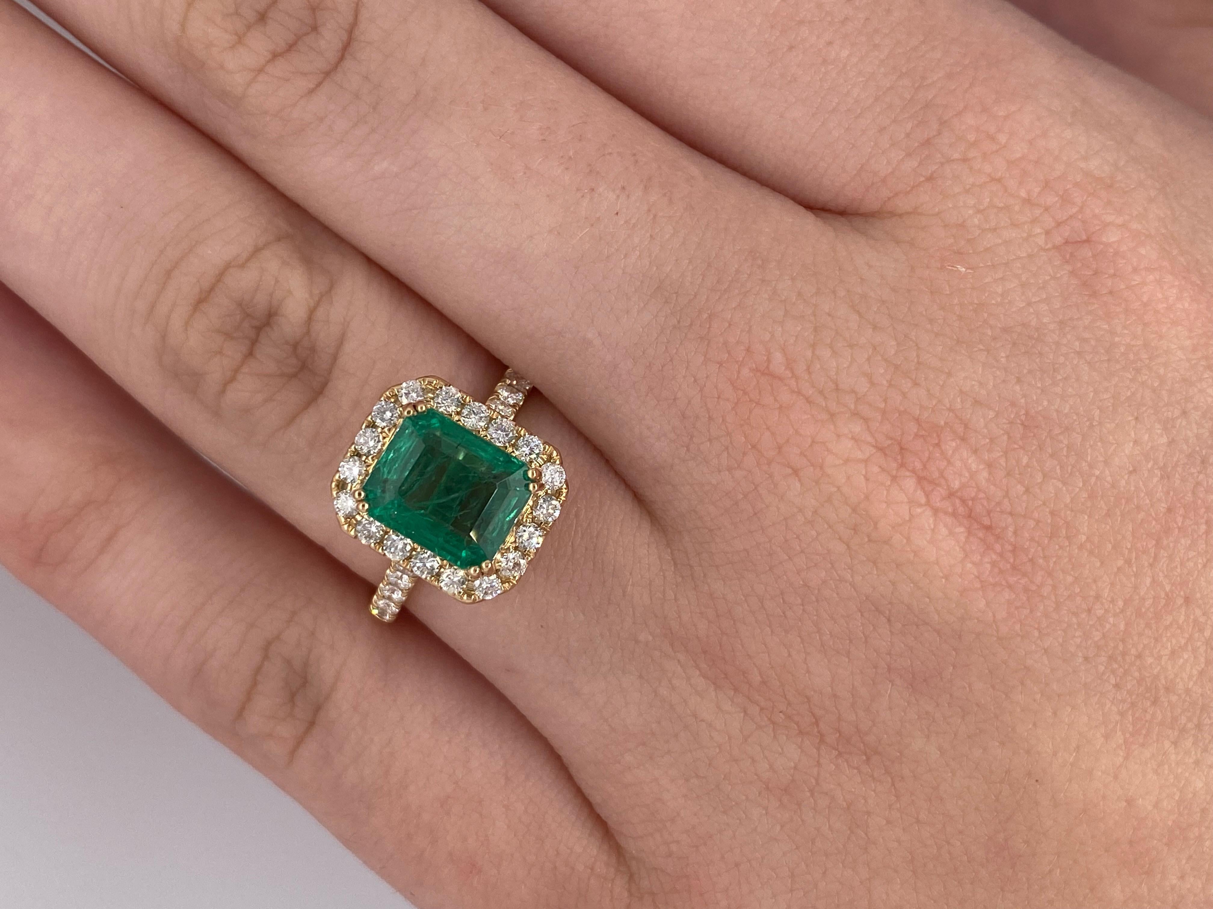 Classic halo ring great for an alternative stone engagement ring or a right hand fashion ring.
This beautiful saturated vivid green Zambian emerald weighs 2.49 carat and surrounded by 0.54 carat total white vs diamonds is set in 18k yellow gold.

