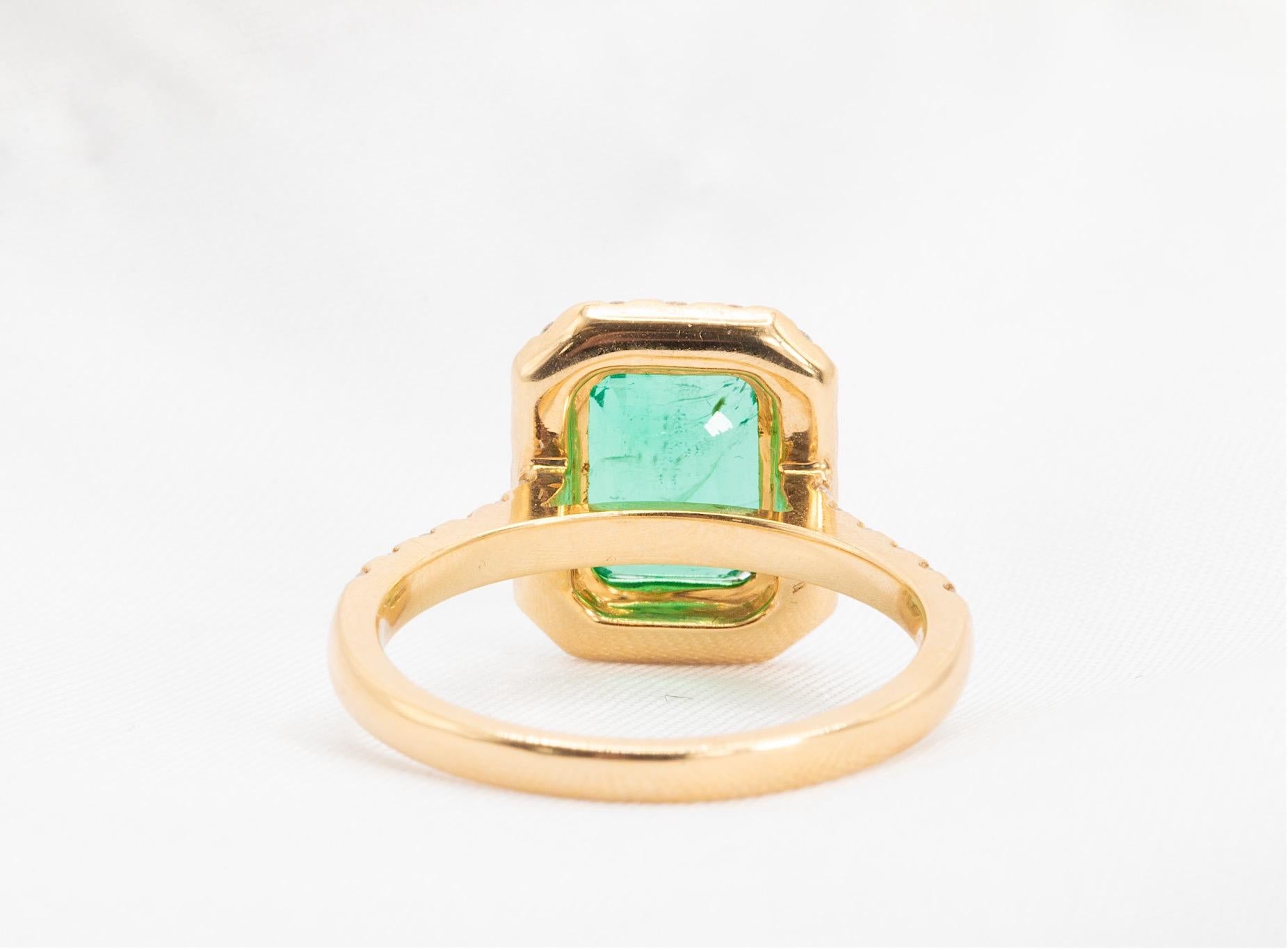 Emerald Cut 3 Carat Zambian Emerald And Diamond Halo Ring In 18k Yellow Gold For Sale