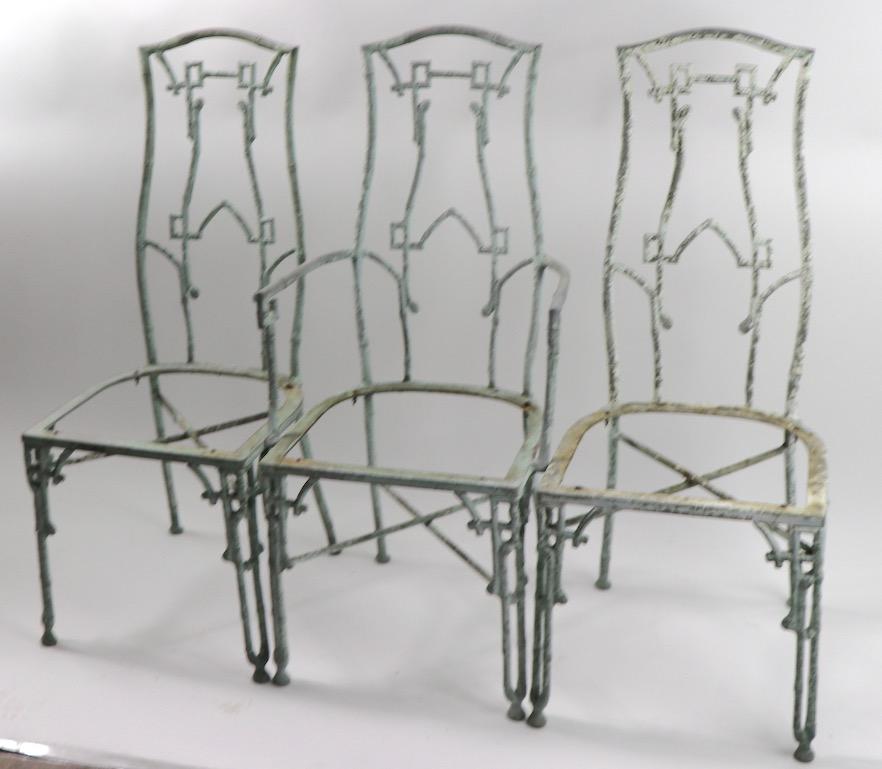 Three dining height chairs, two armless, one arm, all missing seats and will need to be reupholstered. Wonderful worn paint patina creates a charming weathered look, perfect for the lawn, or garden. As this is a odd number of chairs, we have proved