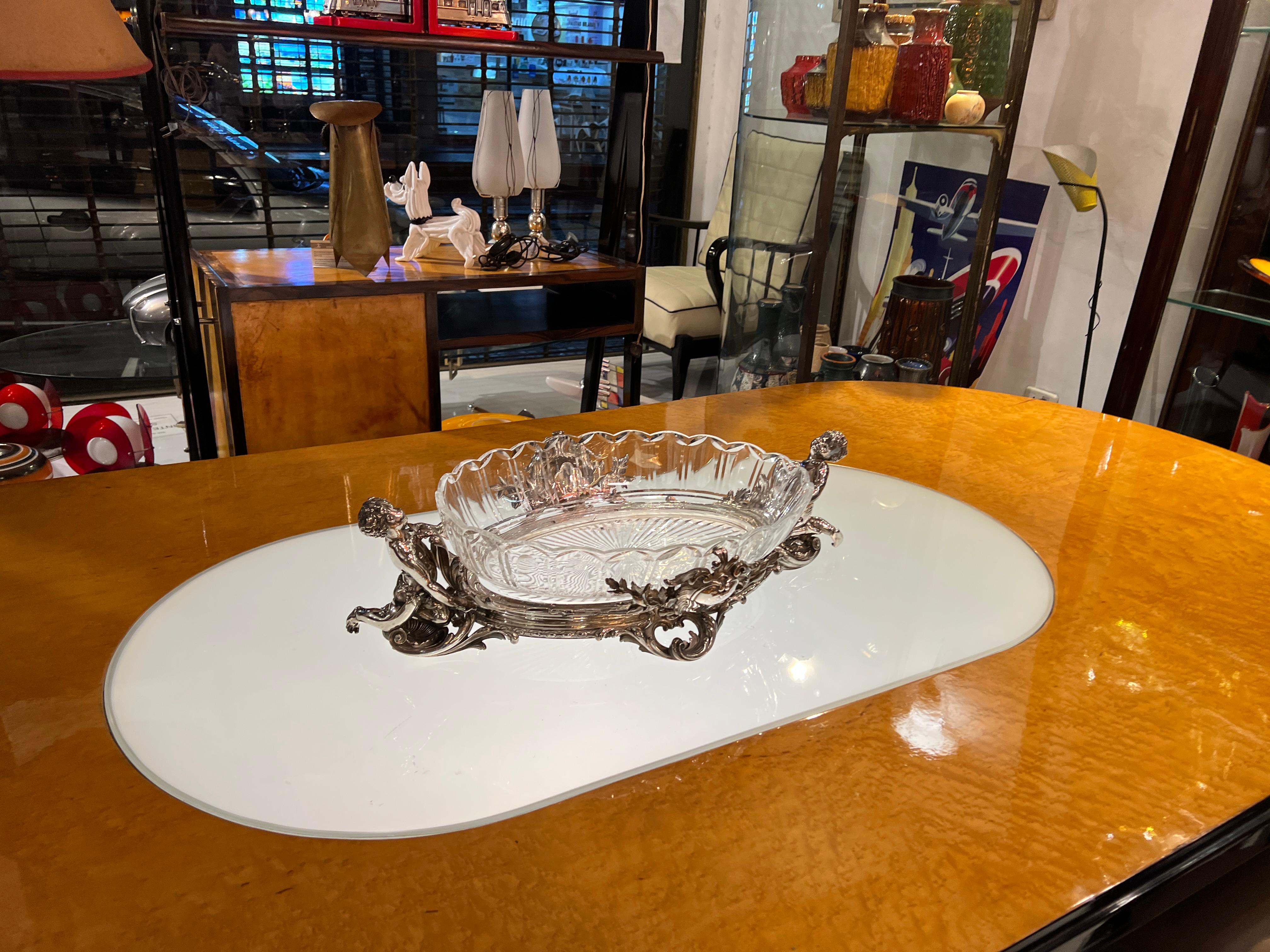 3 pieces Christofle

Measures: Big Centerplace 
65 cm (24.80 inch) long x 18 (7.08) High x 39 (15,35) depth (cm)
Silver plated bronze and crystal
Sign: Christofle , Number: 1391742
2 Small centerpieces
19 cm (7.48 inch) high x 29.5 cm (11.61 inch)