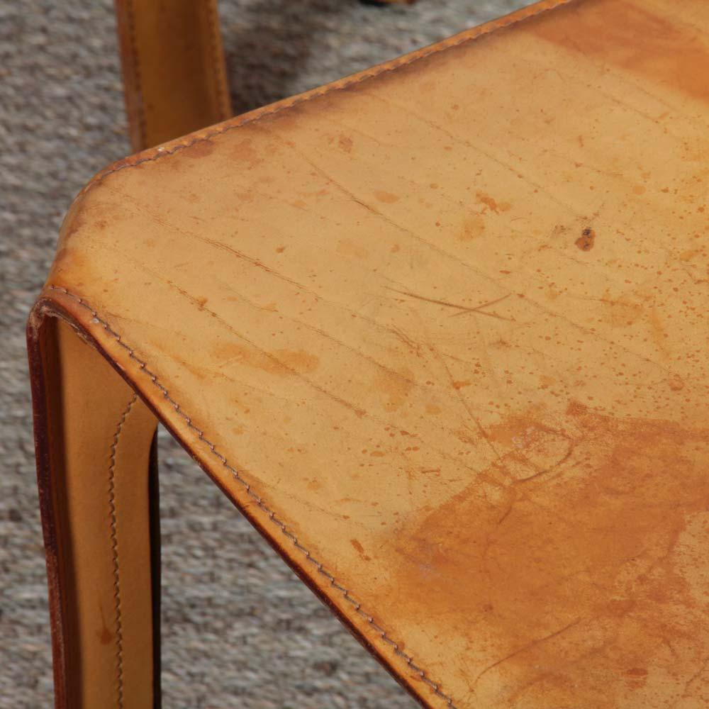 The CAB 412 was designed by Italian designer Mario Bellini for Cassina in 1970. This chair is entirely in leather. This set of 3 chairs has a beautiful patina. 
