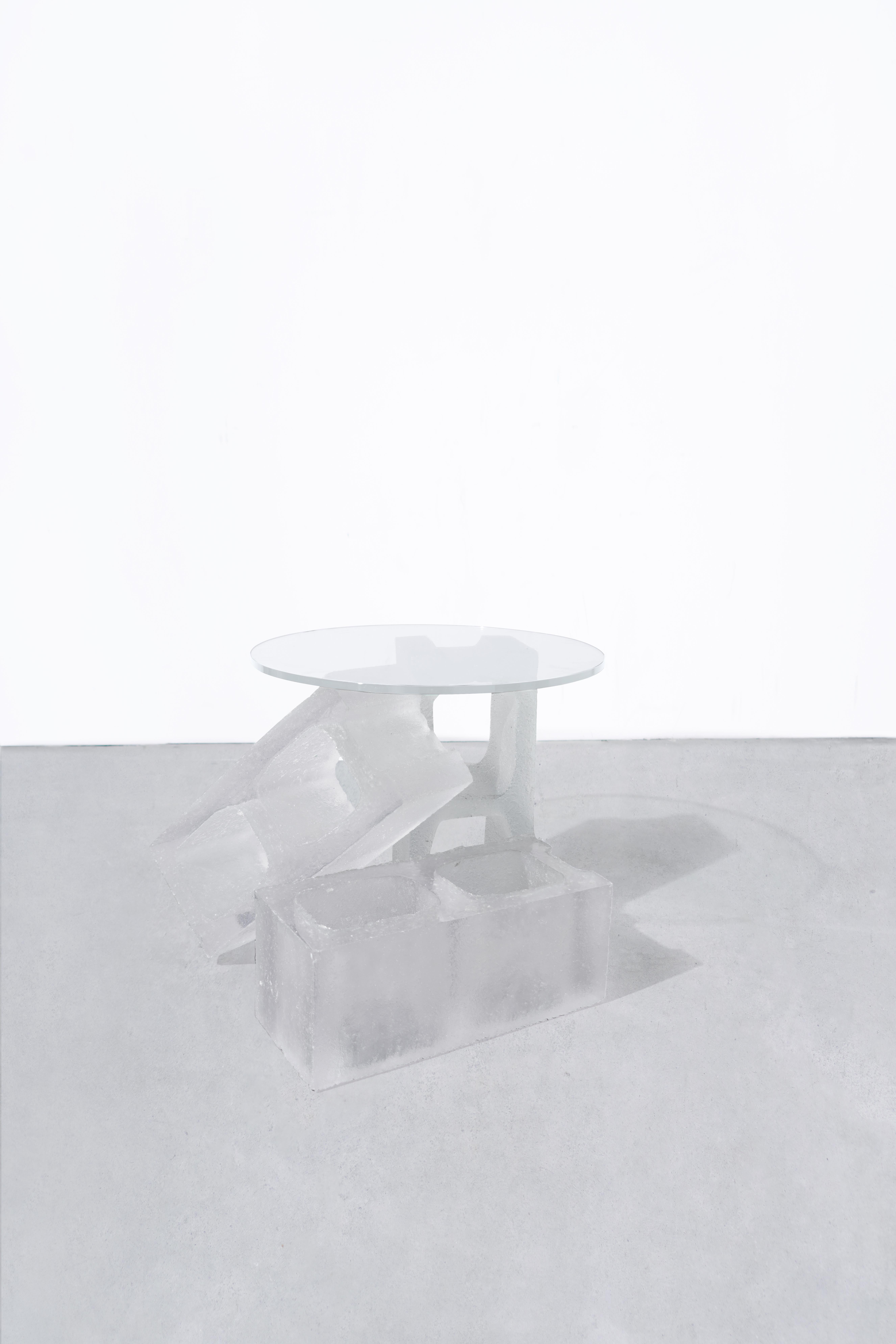 DESCRIPTION
3 hand-molded, transparent resin cinder block, supporting a tempered glass table top.
Starphire glass top.
Modular.
Made to order in nyc.

DIMENSIONS
Cinder Block length 18.75?
Cinder block width 7.5” 
Cinder block thickness