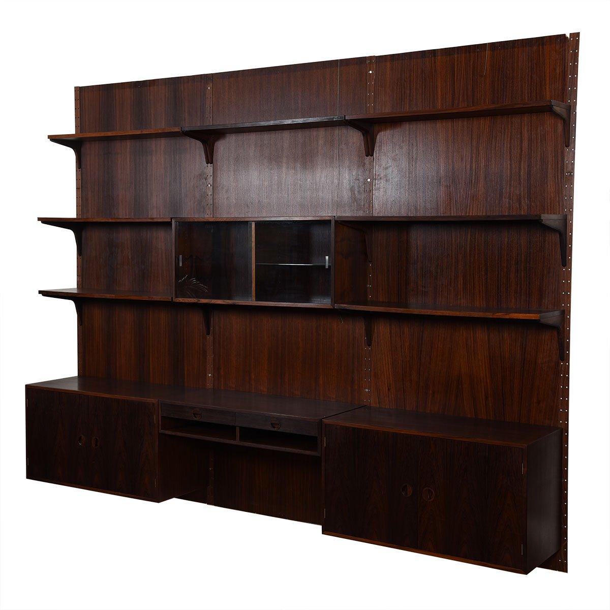 Includes the original rosewood paneling with stunning grain. The paneling does not have to be used to hang the unit, but to not use it would be to miss out on the true beauty of the rosewood. Two deep storage cabinets w/ internal adjustable shelves.