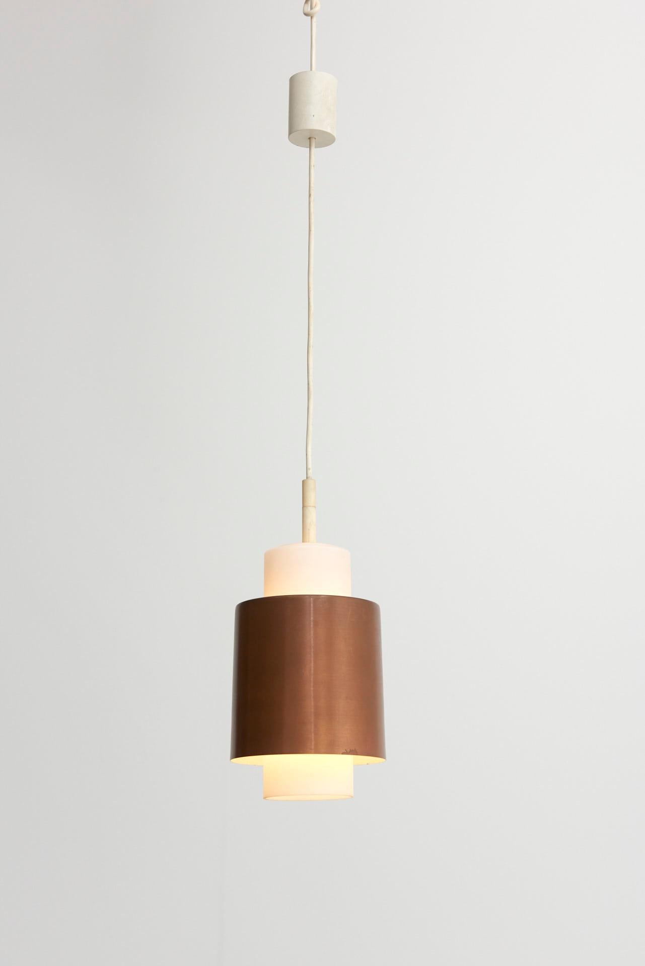 A set of 3 pendant lamps, consisting of an opal glass core with lamp shade in red copper.