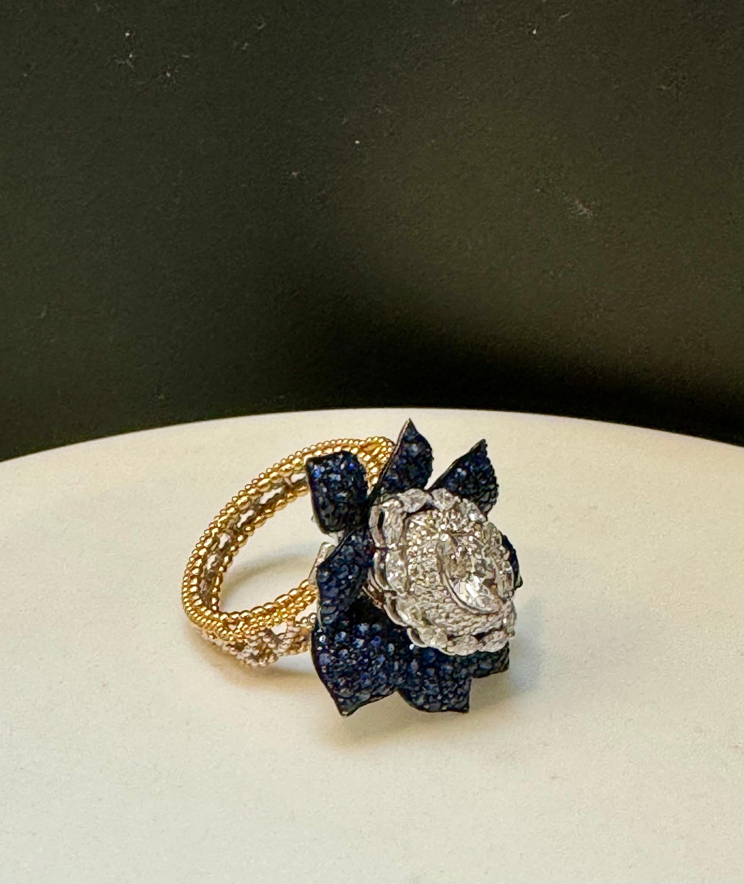 
3 Ct Blue Sapphire & 1.5 Ct Diamond Cocktail Ring in 18 Kt Two Tone  Gold  Size 7
Beautiful Flower Ring
Two tone ring as the band is made out of Yellow gold and top of the ring is White gold.
Pave set Blue Sapphires are making the petals .
Total