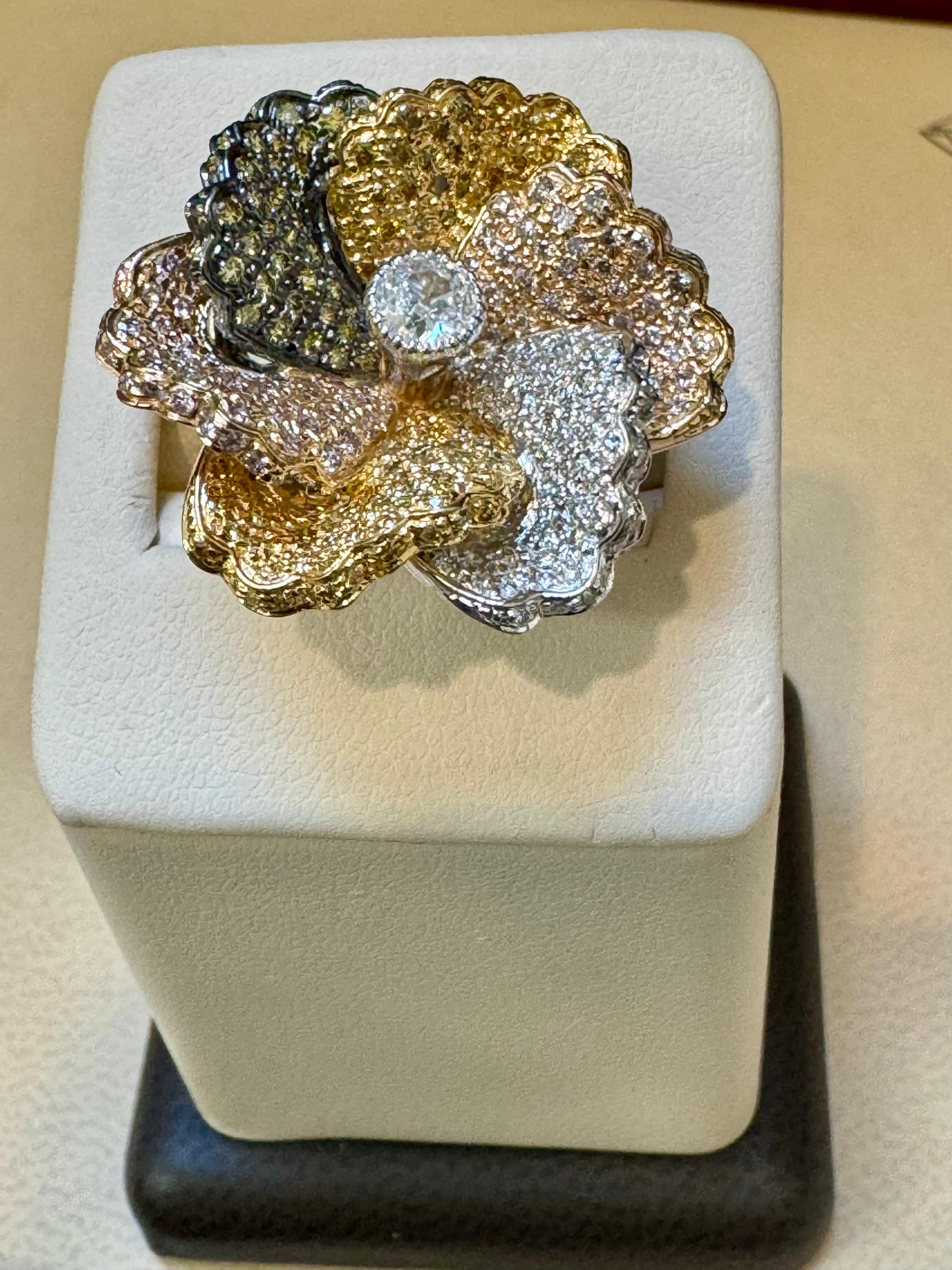 3.3 Ct Natural Fancy Color Diamond Flower Ring in 18 Karat Multi Color Gold Size 6
Approximately 6 Ct Natural  Fancy diamonds are making beautiful petals of flower which has a solitaire diamond in the center.
It has all colors of gold , Yellow ,
