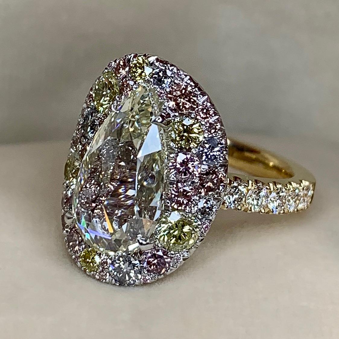 One of a kind ring in 18K White & yellow gold 13,2 g. Set with a 3,08 ct. rose-cut pear shape diamond centerstone, pave set Fancy Pink, blue & yellow brilliant-cut diamonds 1,545 ct.( continuous pave setting under the rose-cut diamond centerstone),