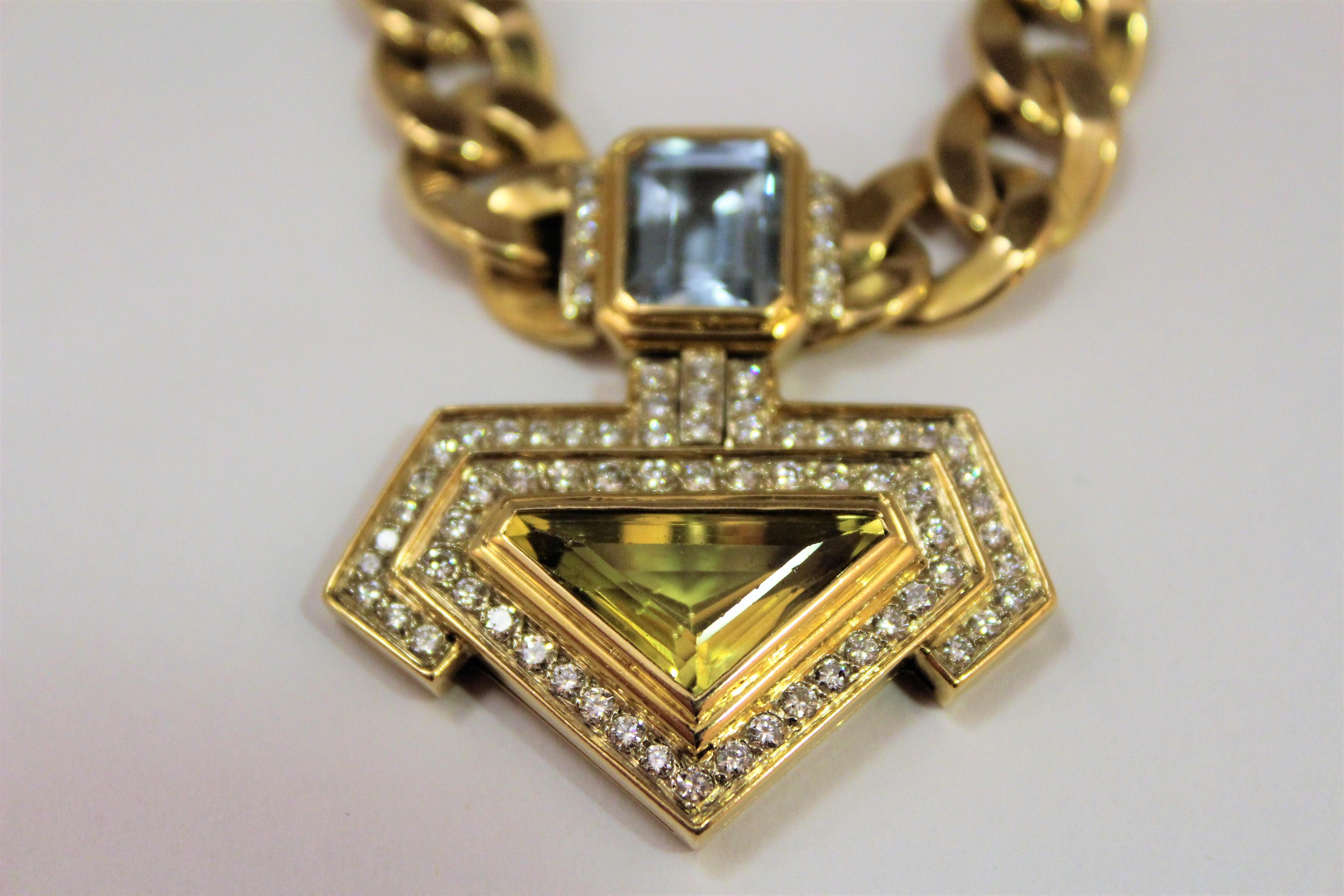 Impressive 18K gold pendant necklace, with
 3 ct blue natural Topaz emerald cut
4.5 ct yellow  Quartz triangle cut
2 ct round diamonds g/h colour, vs purity
total weight 49.2 grams
Italian made in Florence, around 1980s
