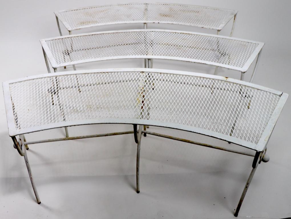 Wonderful group of 3 semi circular garden, patio benches by Salterini. Constructed of wrought iron and metal mesh, all are in very good condition, showing only cosmetic wear to the paint finish, normal and consistent with age. 
These are offered