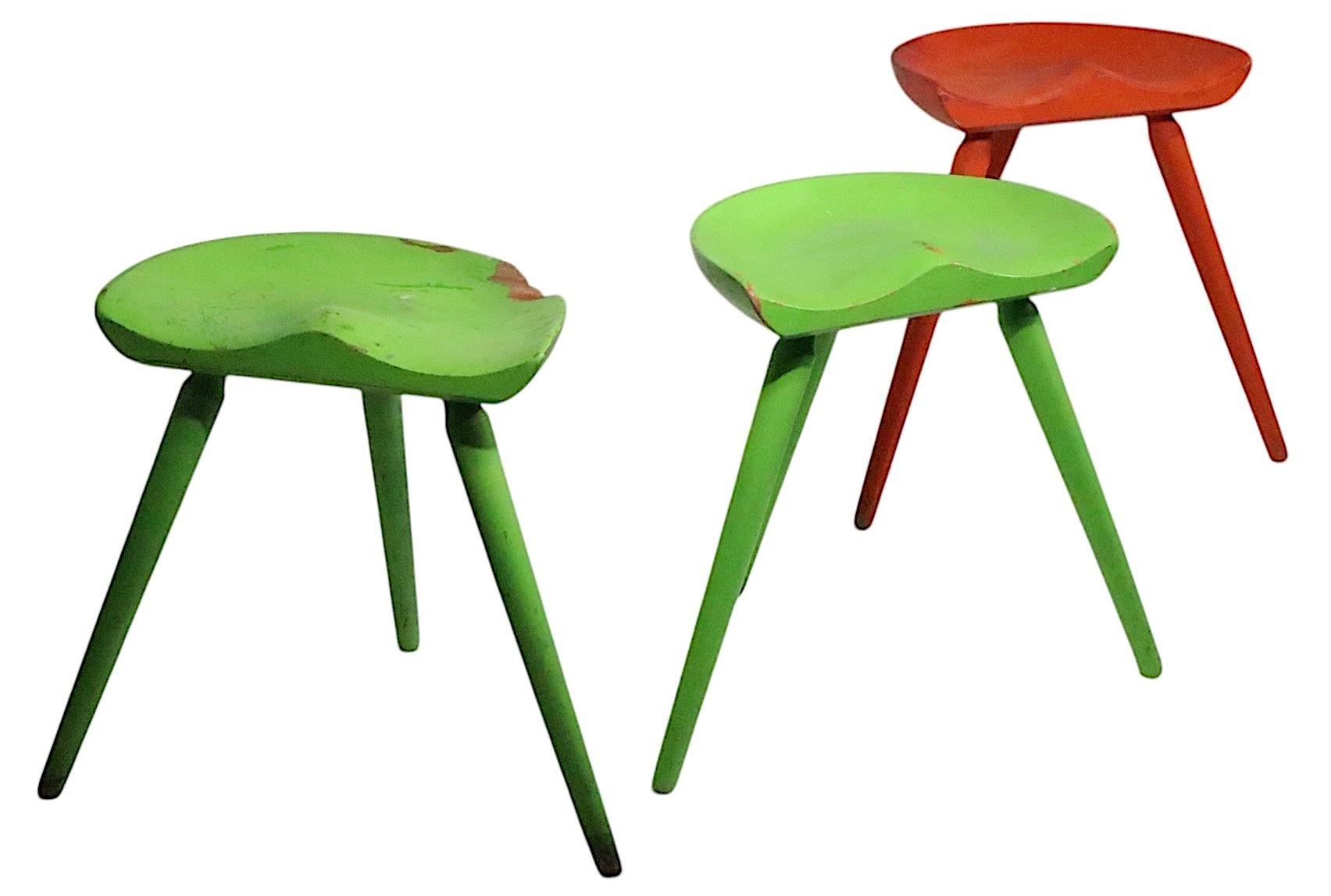 Set of three Danish Mid Century Modern milking stools, design attributed to Arne Hovmand - Olsen, made in Denmark, circa 1940/60's. The stools are in as found condition, specific condition report as follows. All three are solid, and sturdy, all