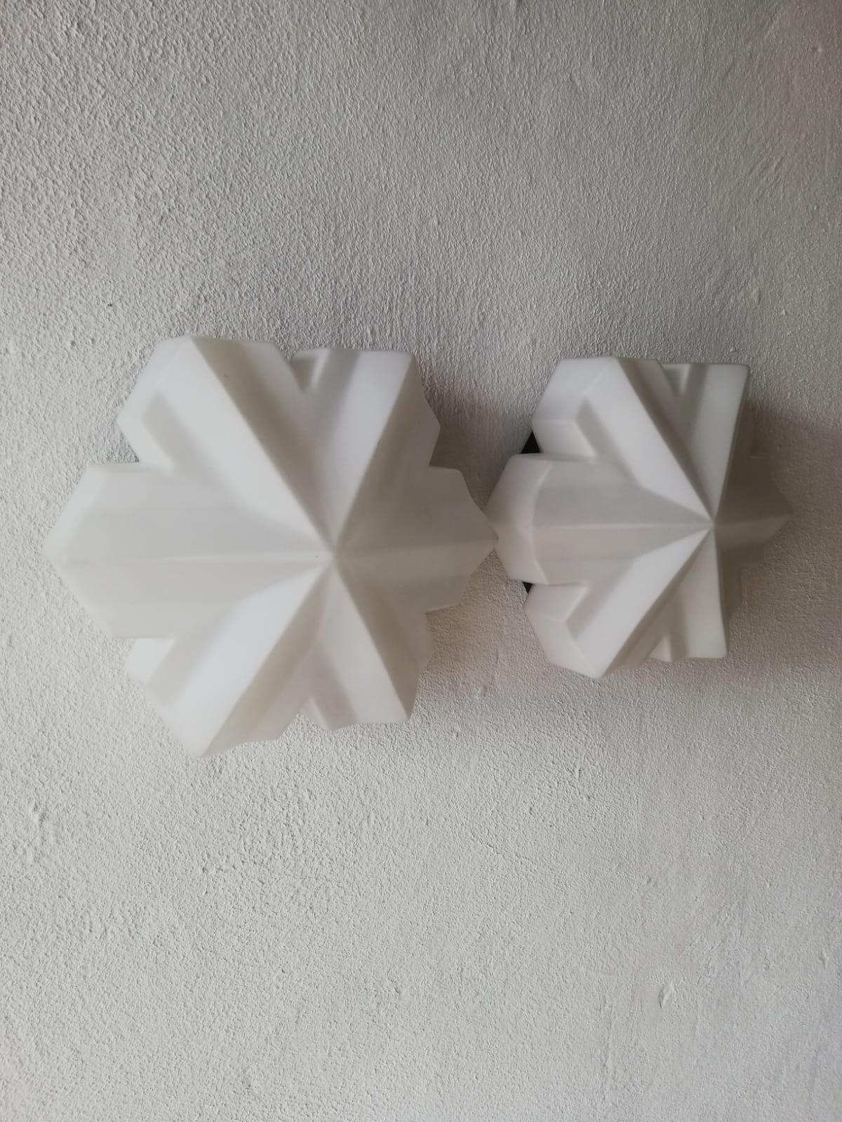3 dimensional hexagonal opal glass pair of wall lamps by BEGA, 1960s Germany

Rare and Minimalist clover leaf shape wall sconces.

Lamps are in very good vintage condition.

These lamps works with E14 standard light bulbs. 
Wired and suitable
