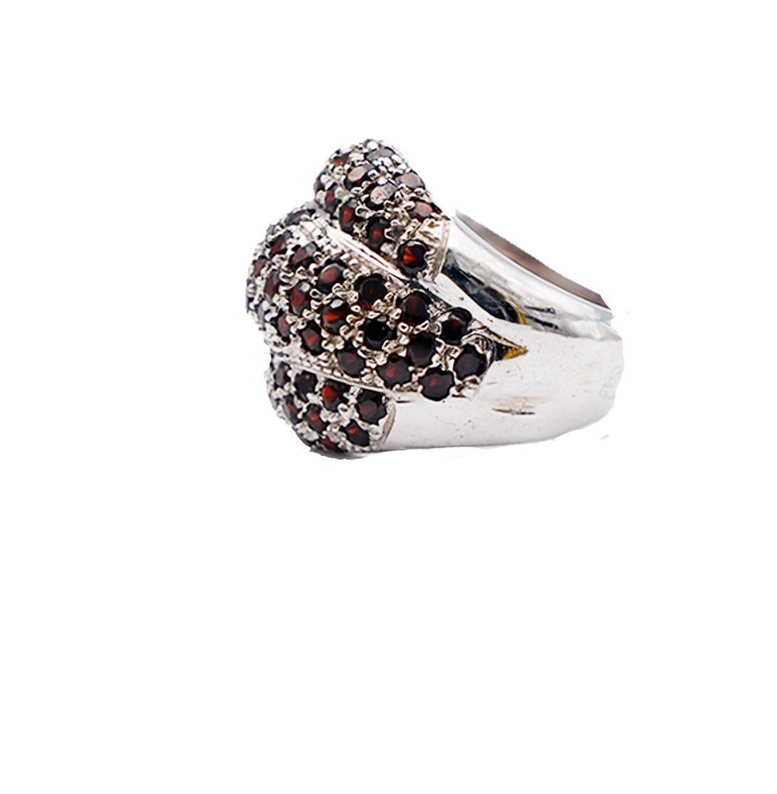3 Carat Garnet 20mm Dome Ring
Lovely ring consists of three bubble domes set with red garnet gemstones. The stones are round and have an estimated weight of 3 carats. 
Rich setting, pave workmanship set in sterling silver. 
Grams weight is 7.6 and