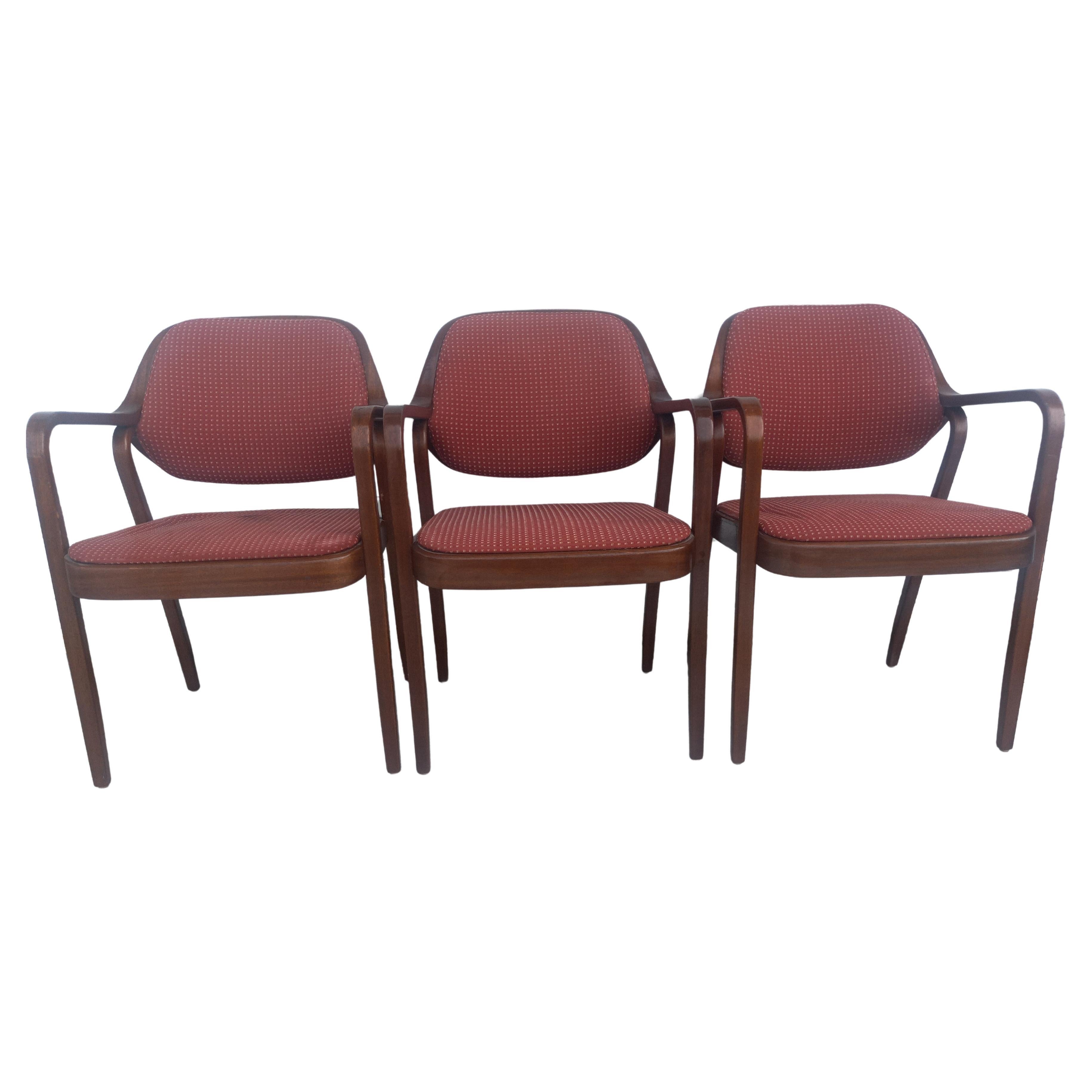 These are Don Pettit bentwood armchairs. They were designed for Knoll International. They have bentwood arms and are upholstered in a Knoll fabric.

There are 3 chairs available.