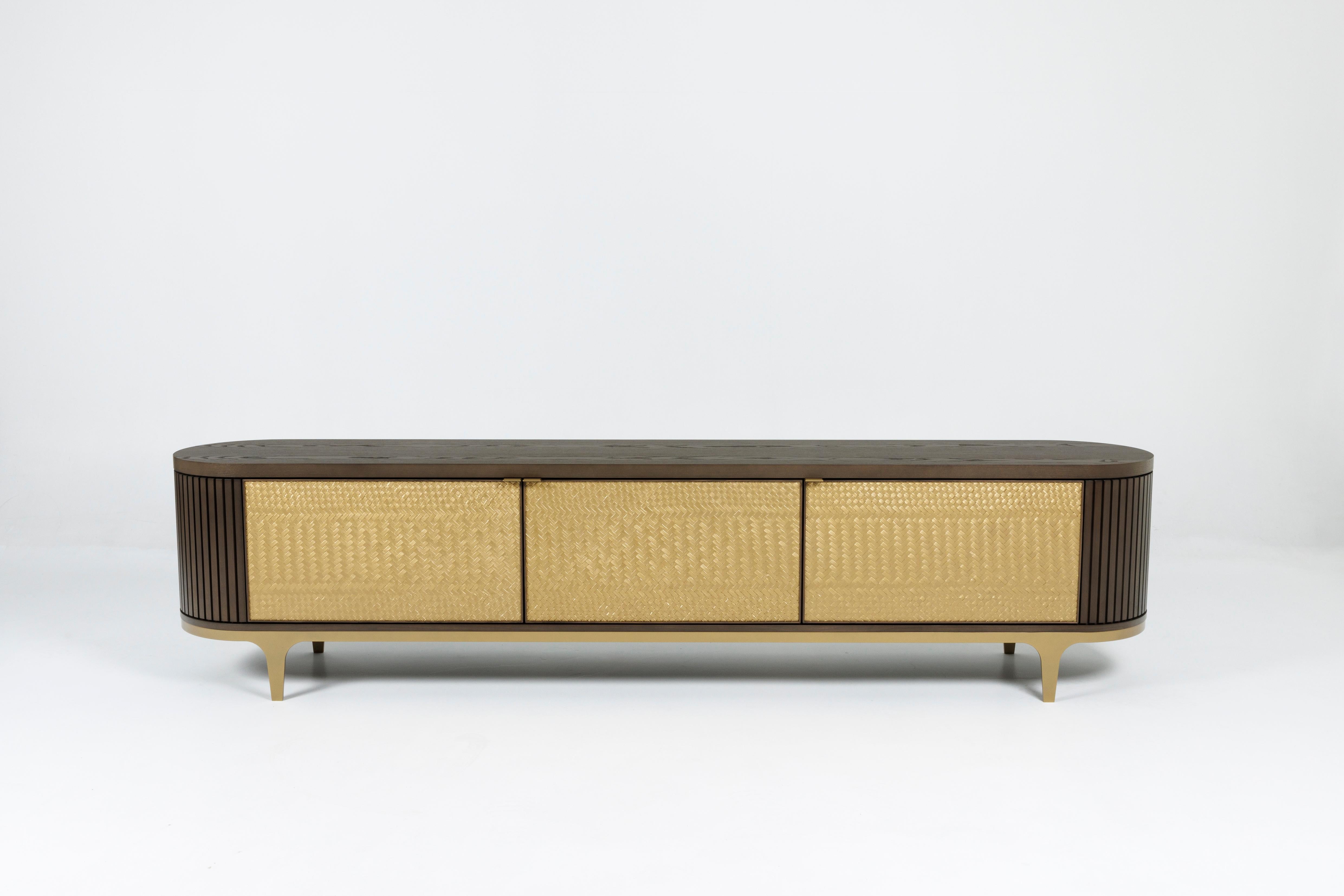 The Weave credenza combines traditional craftsmanship using wood and metal, with the skill and artistic form of three woven triptych panels created by Māori rāranga artist Bronwynn Billens, Ngati Tama, Te Atiawa, Te Arawa. The result is a
