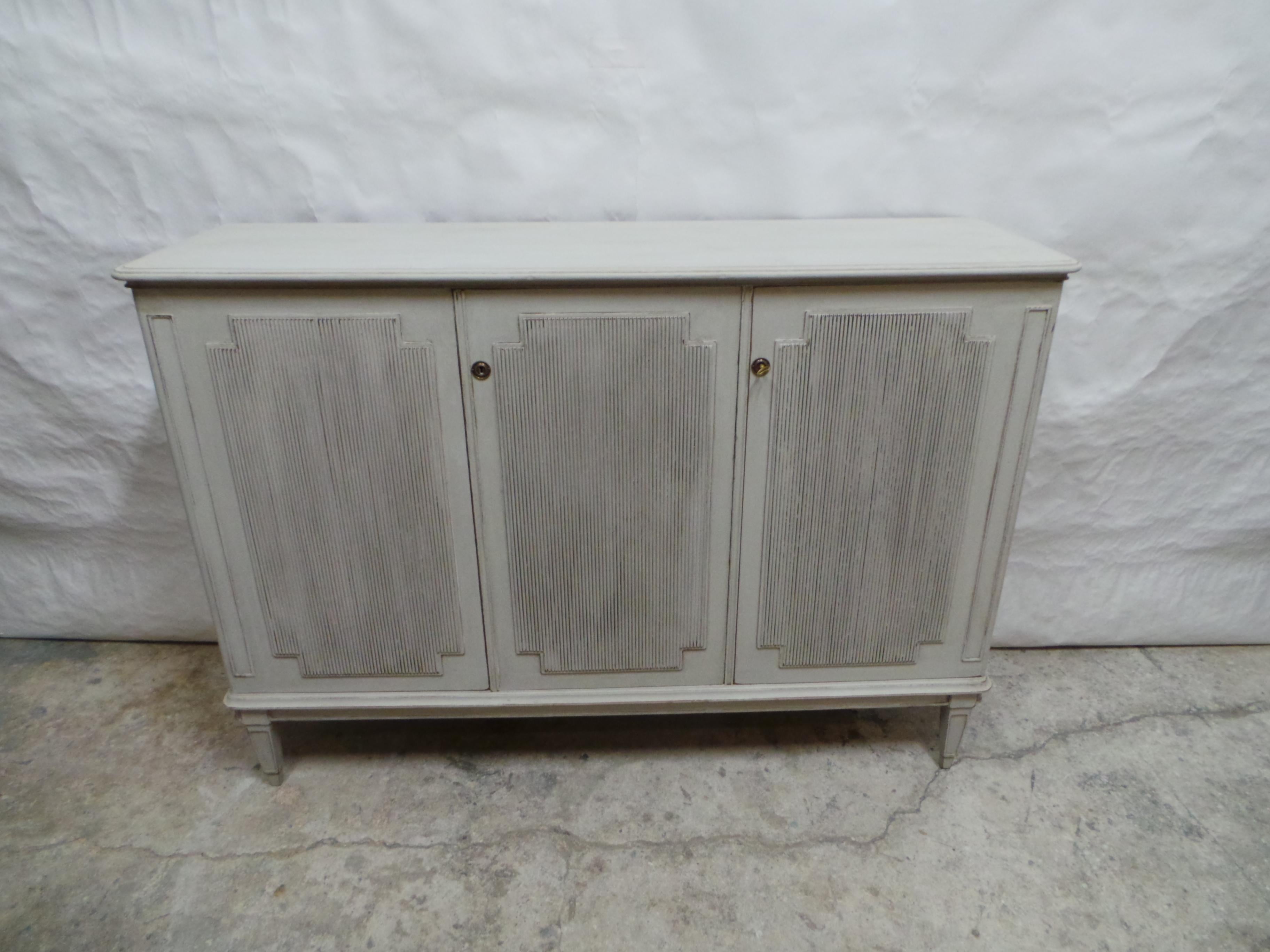 This is a 3 Door Swedish Gustavian Style Side Board. its been restored and repainted with Milk Paints Oyster White.