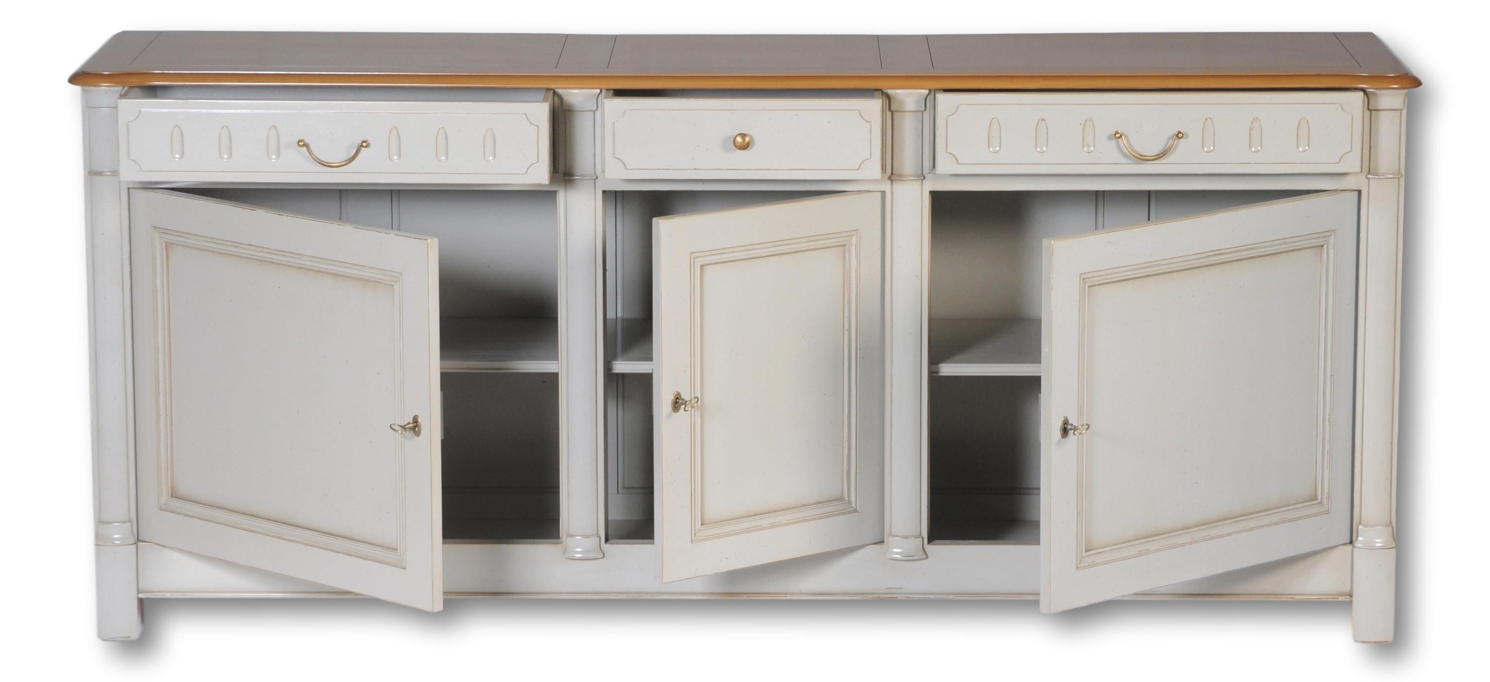 This Buffet is made out of French solid cherry wood . It features three drawers with dove mounted fronts, three doors and an inside cherry shelf. 

The top in cherry wood is stained. The rest of the structure lacquered in light grey gives this