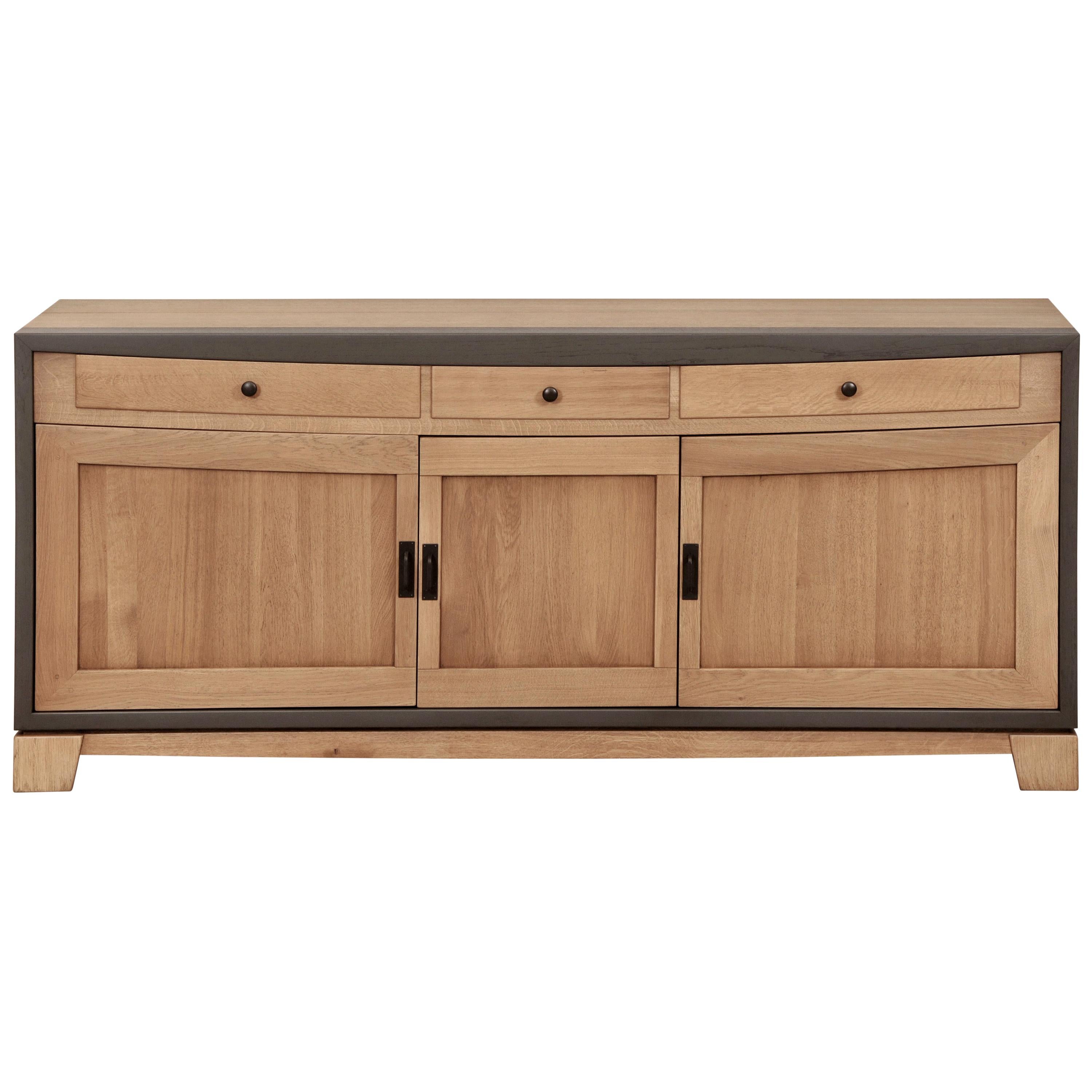 This 3 doors sideboard is made of French solid Oak and designed by the French Designer Christophe Lecomte. 

- 3 wooden doors with damped hinges 
- 1 inner partition for 2 storage units
- 1 wooden shelf on each side of the divider
- finish: chestnut