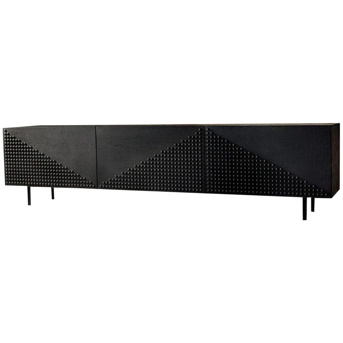 Just as punk fashion made the 1970's cool yet never really mainstream, this all black riveted high-end cabinet designed by Larissa Batista is a blastoff from her design studio to the world. When set out to design the Tigah collection, Larissa