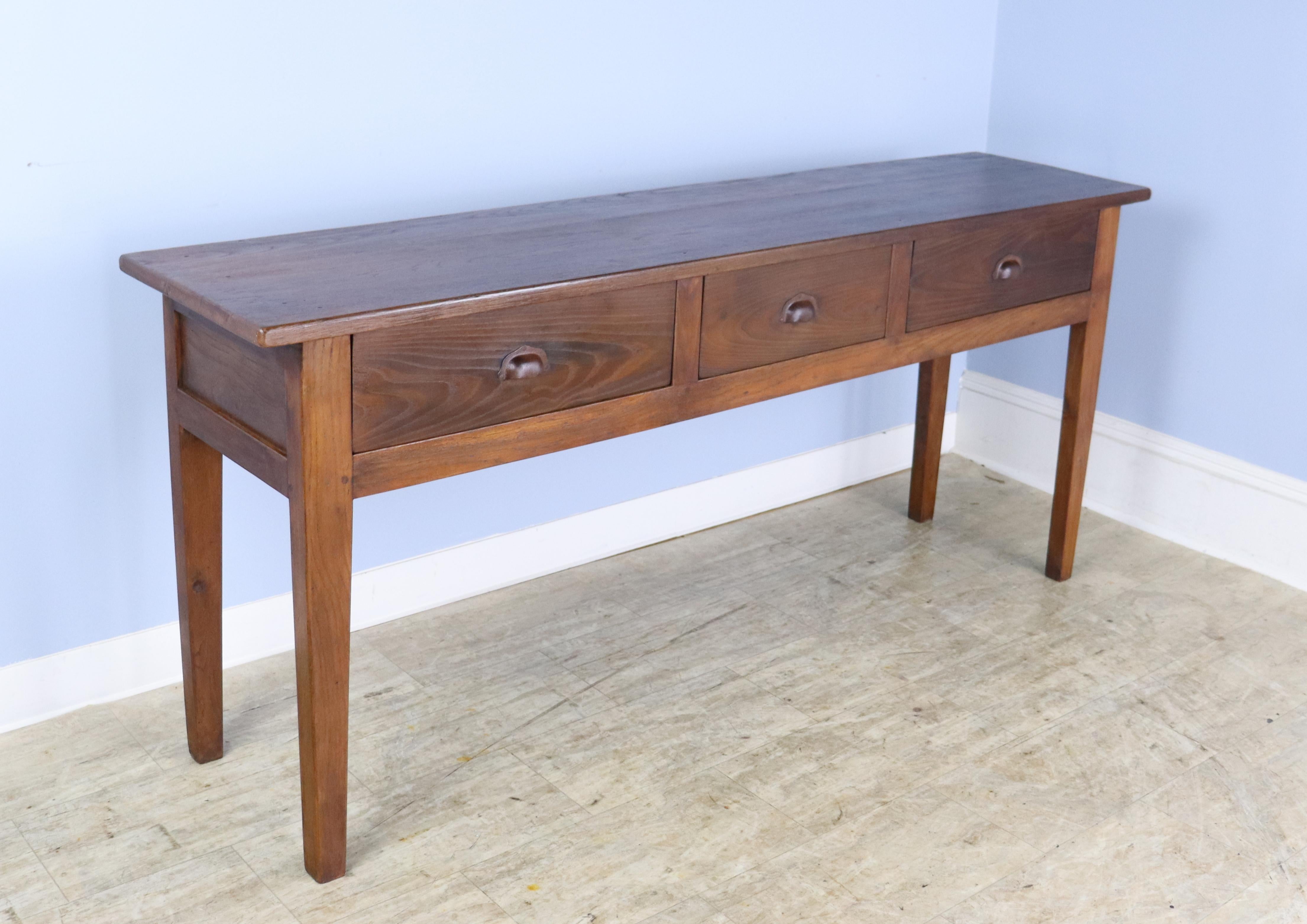 This handsome chestnut piece boasts the Classic three-drawer style on sturdy, slightly tapered legs.. At 17