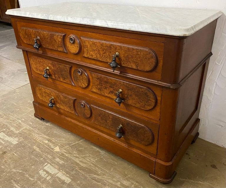 A fine antique Victorian 3 drawer marble top chest. This commode or dresser is hand crafted in burl walnut with dovetail drawers. The teardrop pulls are especially handsome giving the COD added character. A wonderful addition to any room.

 