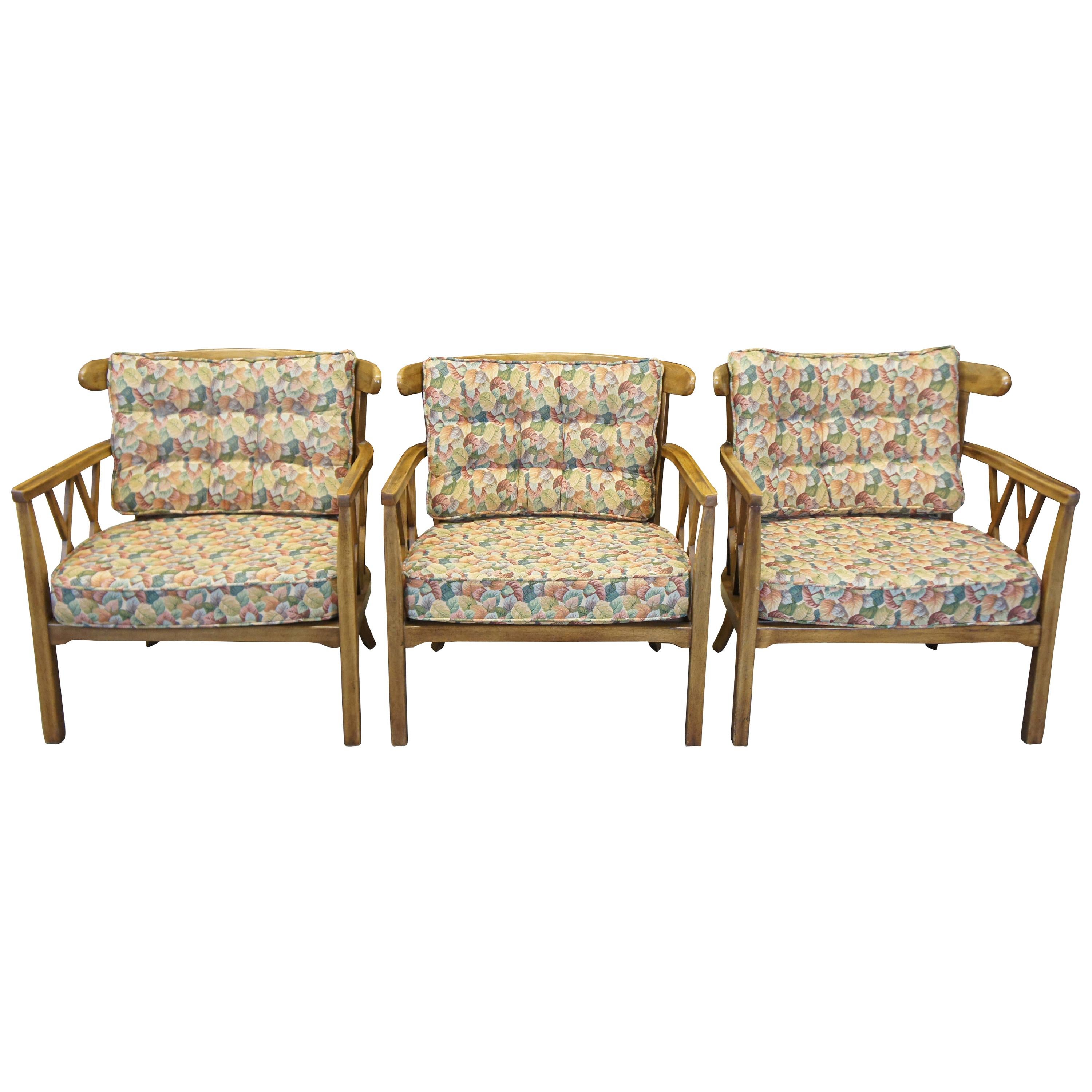 Three 1959 occasional armchairs by Finch Furniture for Thomasville Chair Company. Made from walnut with a barrel back design and unique x shaped supports. The chairs feature a floral cushion and back support.
 