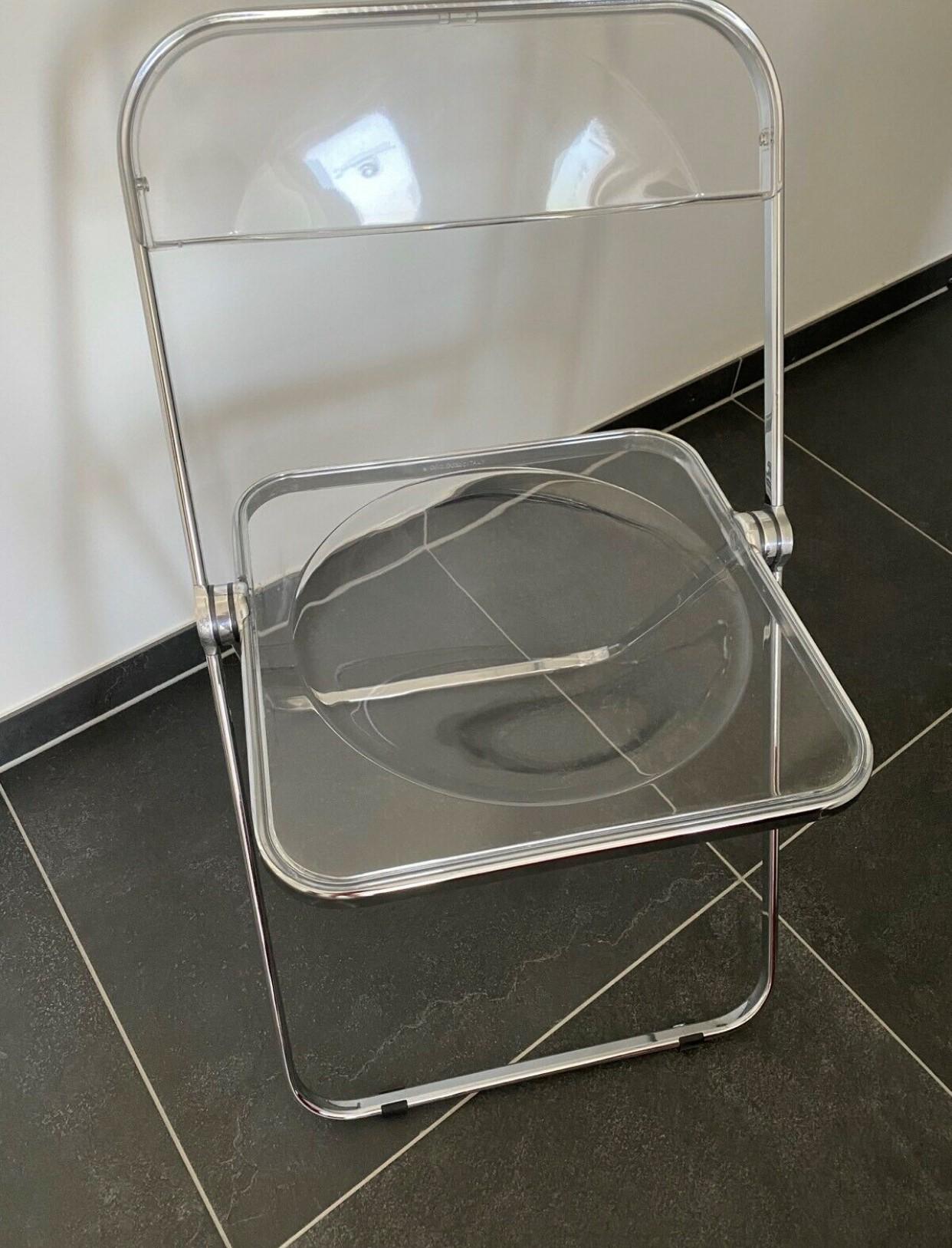 3 Space Age chrome and transparent lucite folding chairs designed by Giancarlo Piretti for Castelli, Italy. 

With steel frame, seat and back in clear lucite, it represents the realization of “democratic design” and is exhibited at the MoMa museum