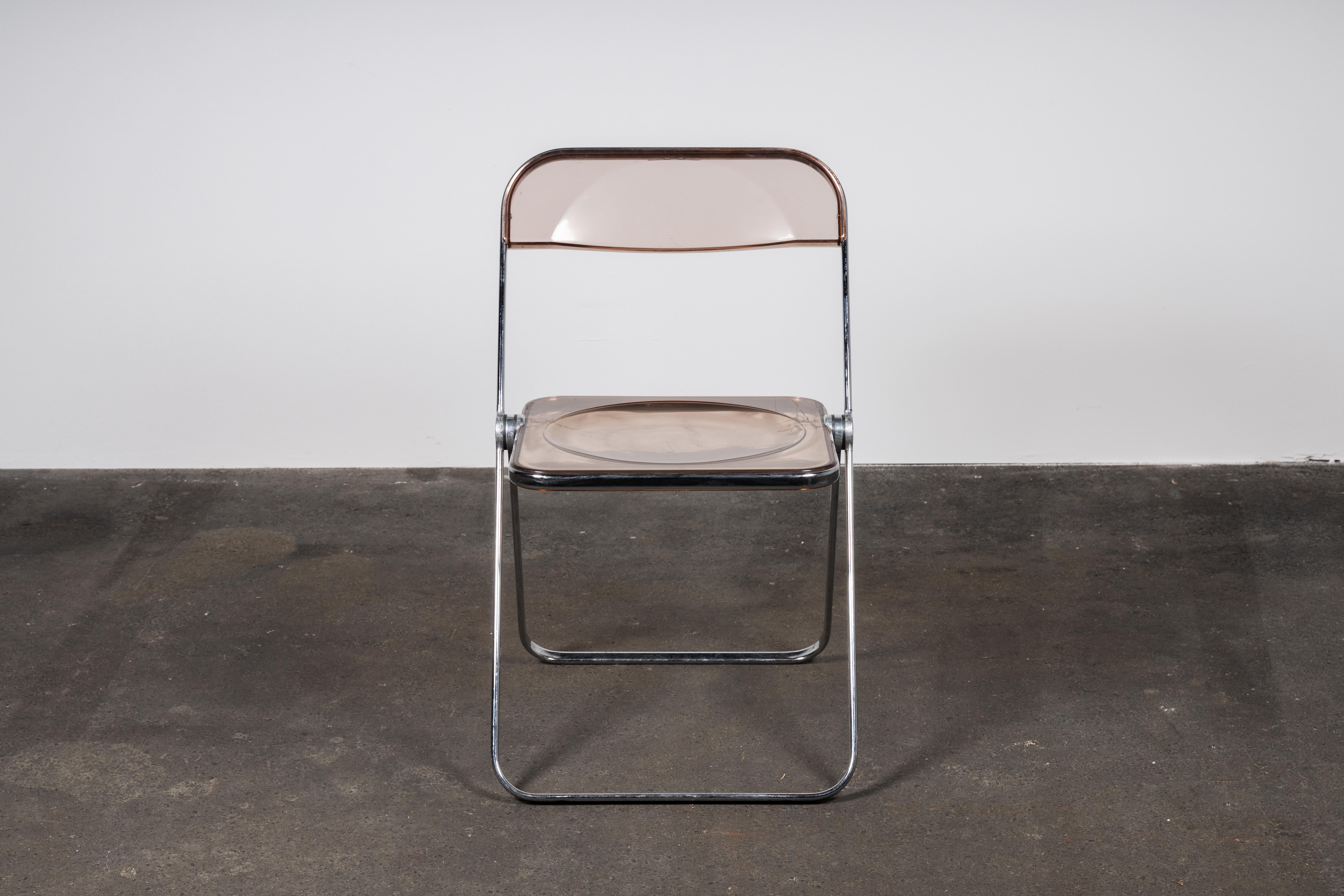 3 Space Age chrome and transparent lucite folding chairs designed by Giancarlo Piretti for Castelli, Italy. 

With steel frame, seat and back in clear lucite, it represents the realization of “democratic design” and is exhibited at the MoMa museum