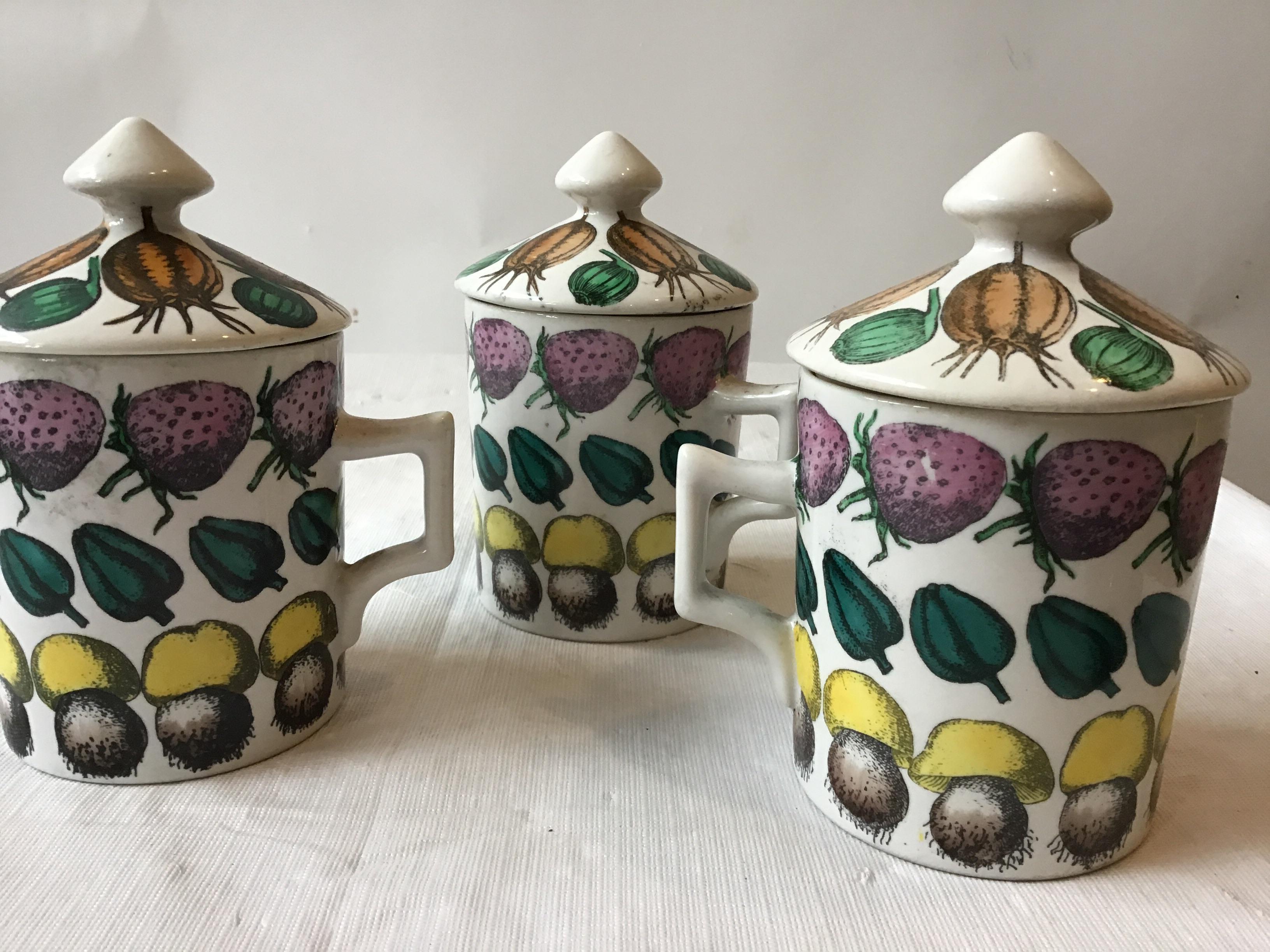 3 Fornasetti 1960s Giostra Di Frutta mugs with lids.