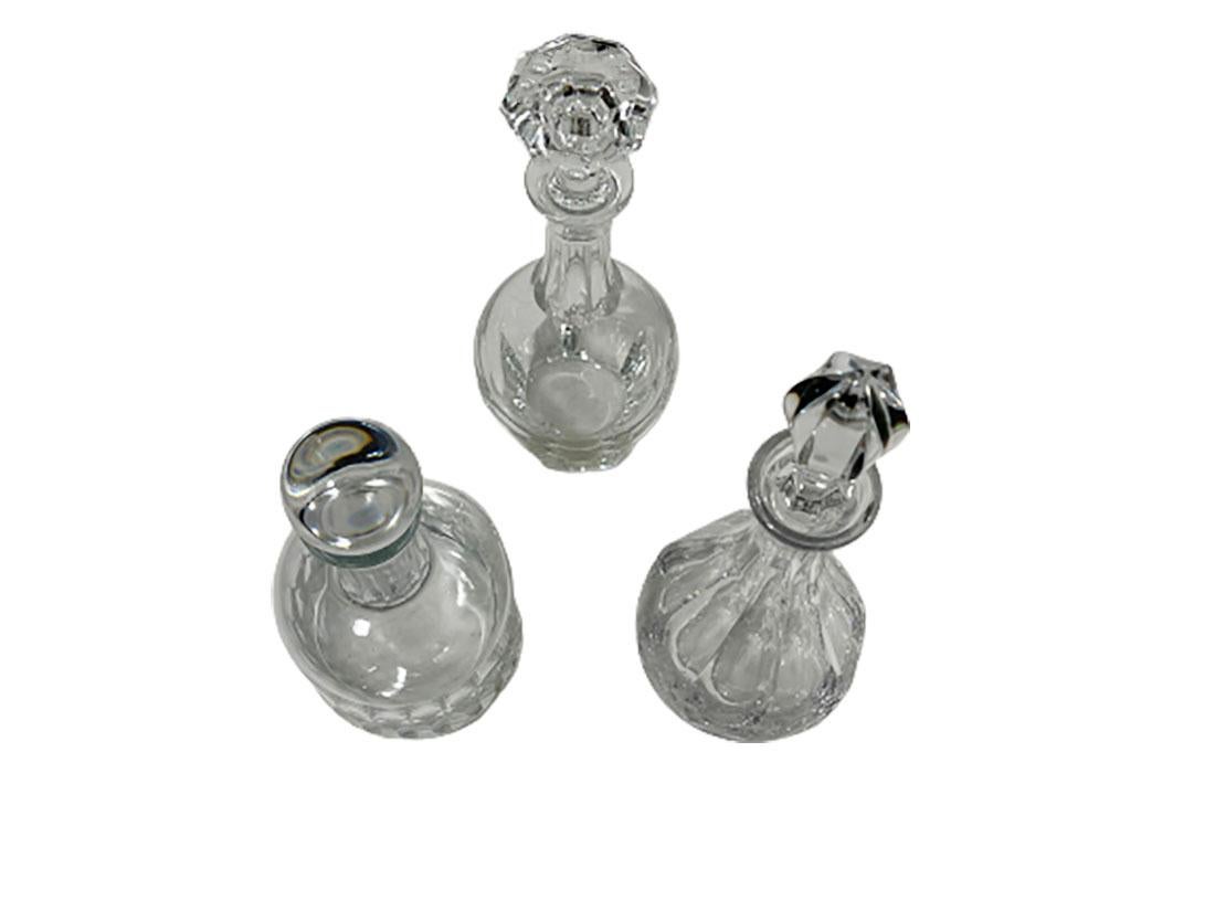 3 French crystal decanters, 1970-1980.

3 Crystal decanters in various models and sizes. 1 Decanter marked on the bottom (etched) and labeled (faded) of the brand Courvoisier, Baccarat crystal, France. 
The measurements are 34 cm high (30 cm and