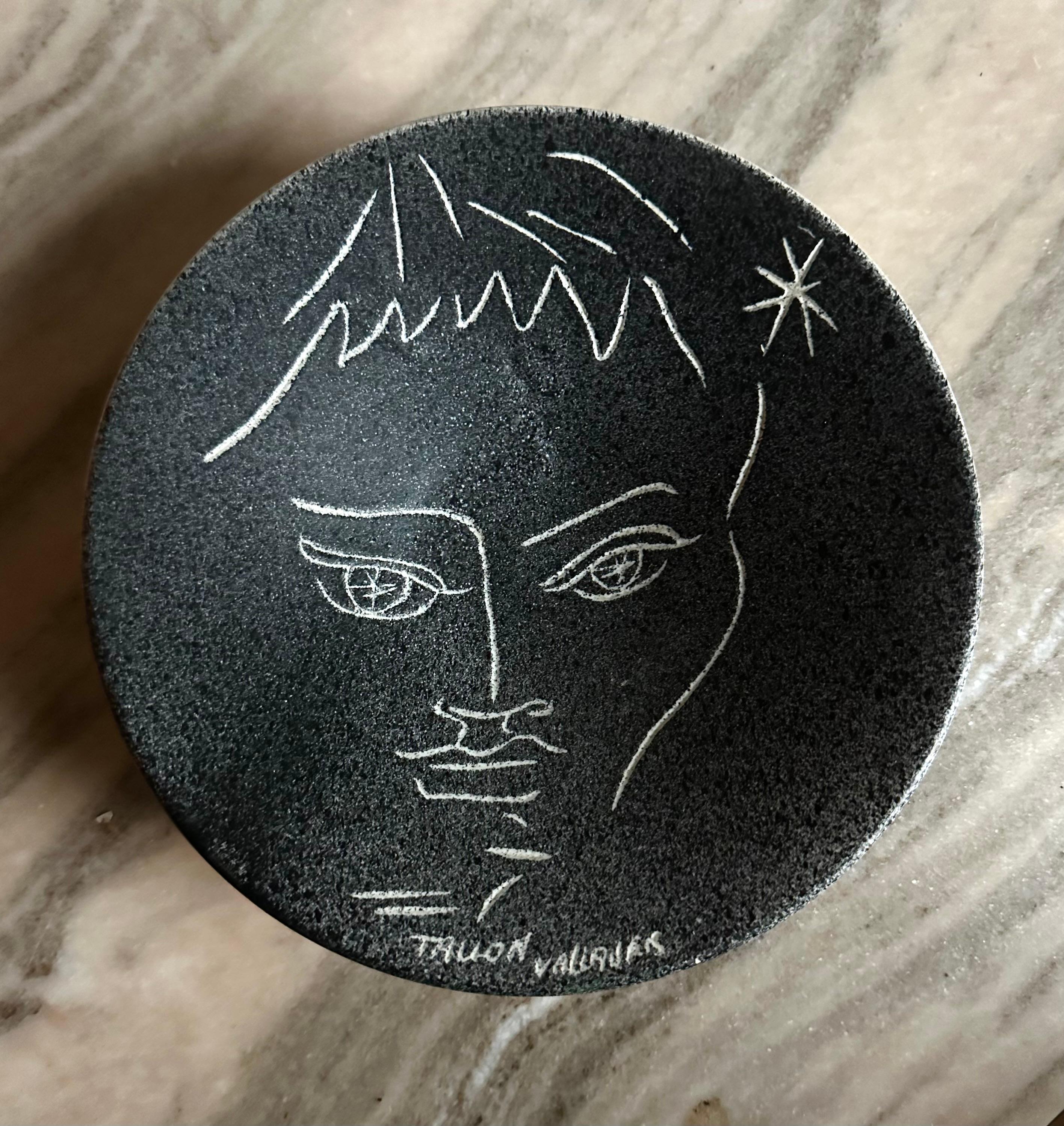 Three whimsical artist thrown and decorated plates. One with a classic Jean Cocteau style line drawing of a devilish figure, signed 