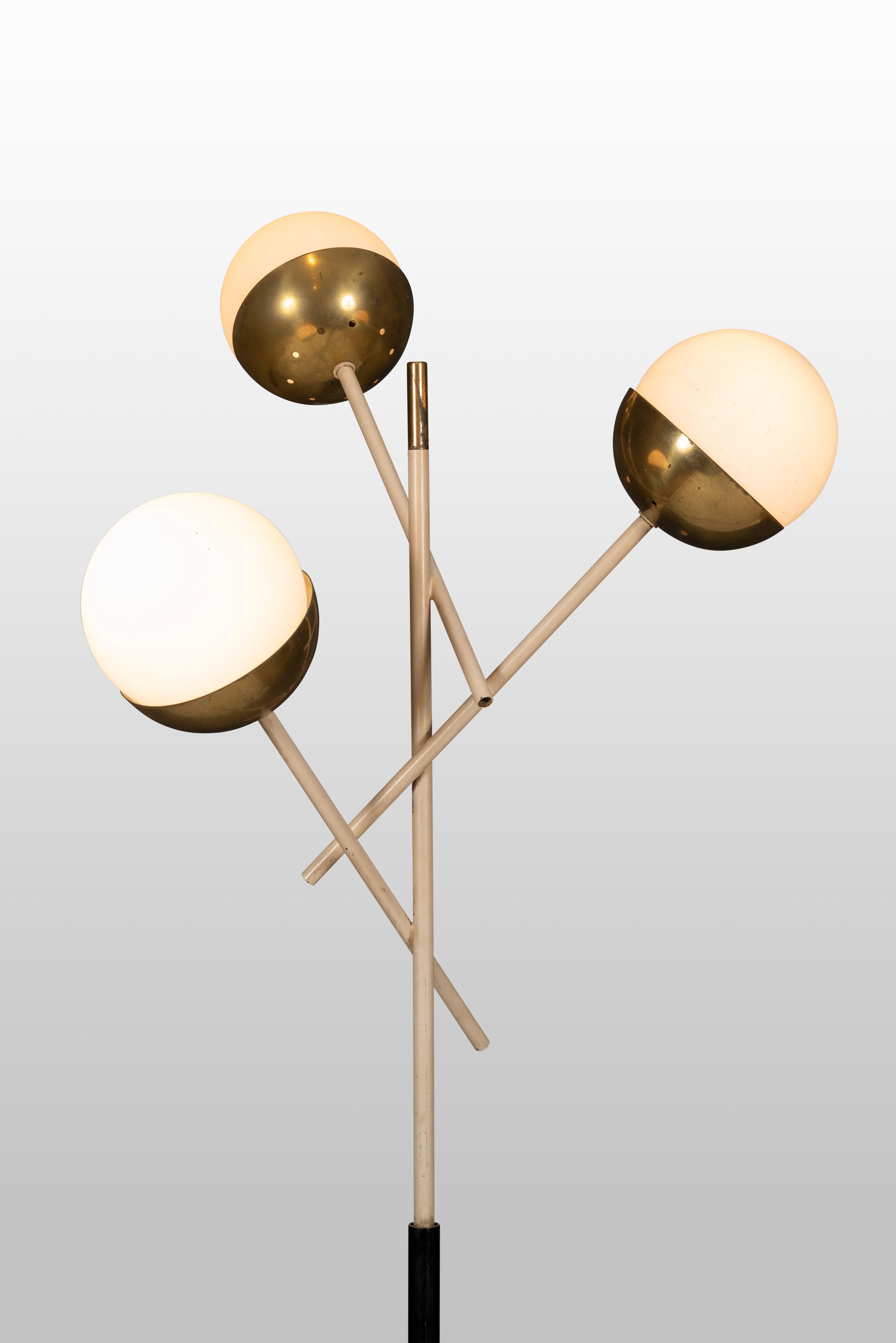 Stilnovo floor lamp with three opaline glass lantern shades suspended on gilt lacquer arms and black enameled stem ending on Carrara marble base, Italy, 1950s.