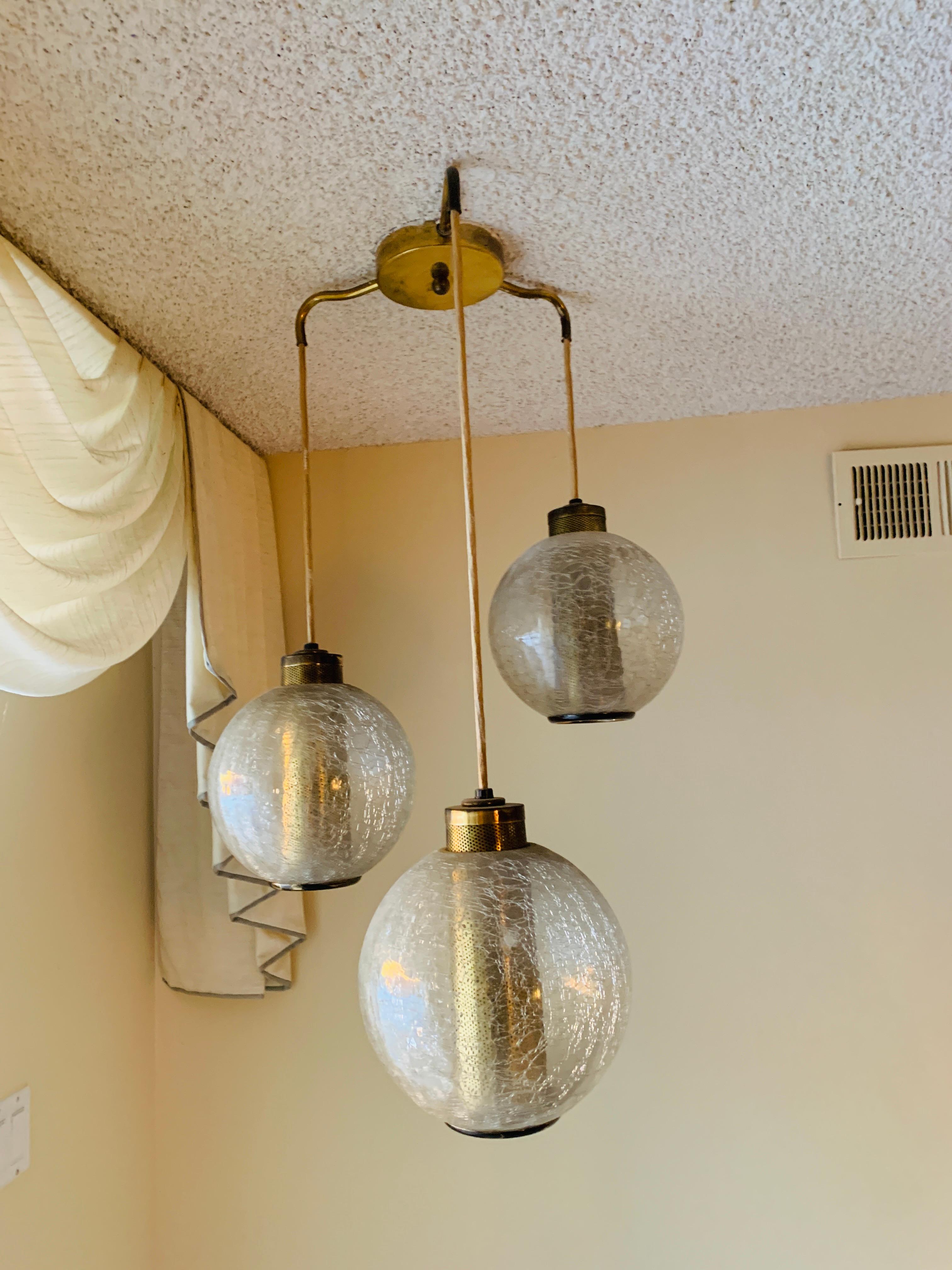 Beautiful pendant/chandelier in crackled glass and brass. The piece is from the 1960s or 1970s and is in excellent condition, one owner and at the same house since purchased. Fully functional.

Measurements:
36 inches high (lowest glove x 23