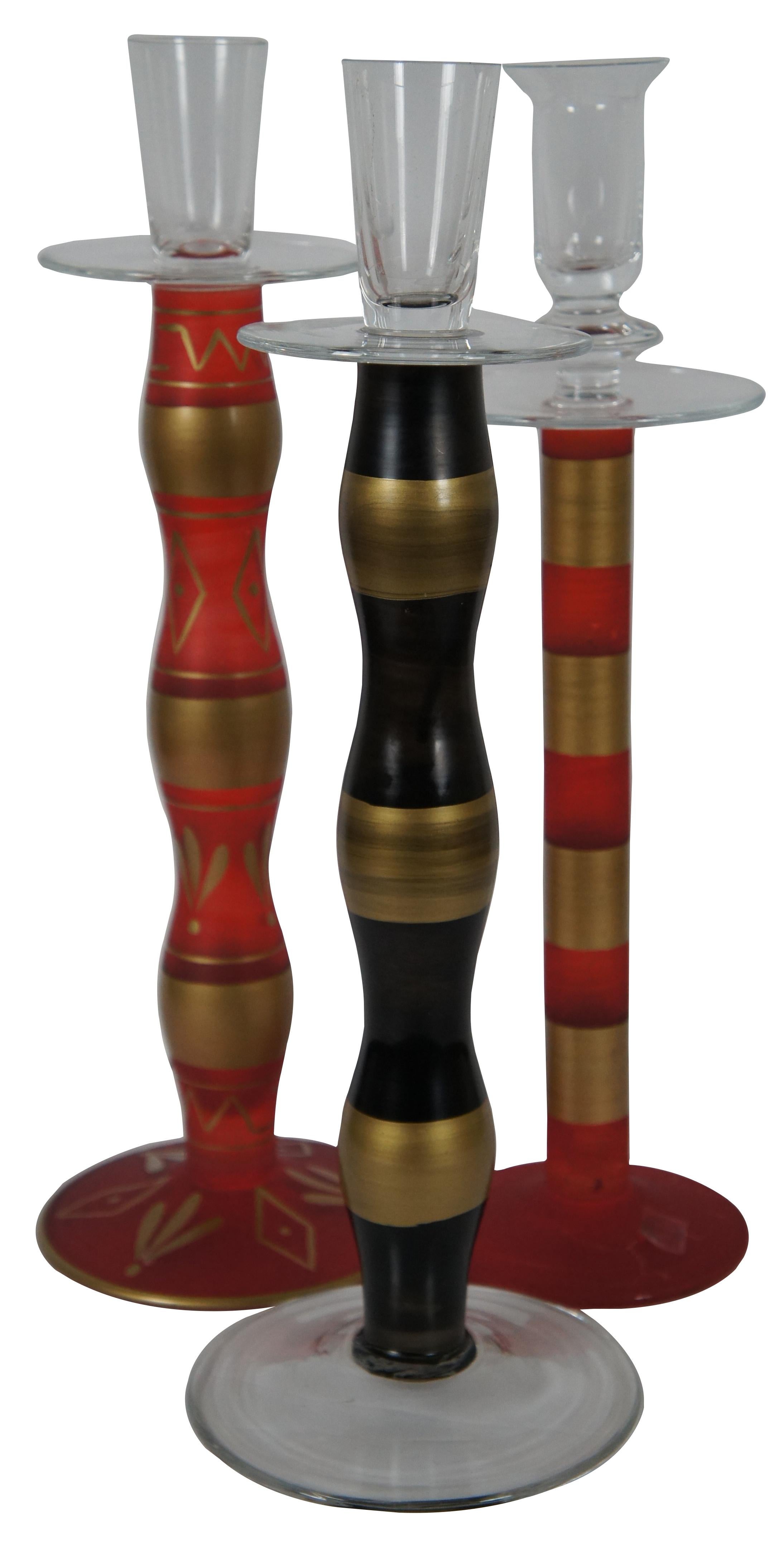 Set of three vintage hand blown and painted glass candlesticks in red and gold, and gold and black, made in Romania. Measure: 14