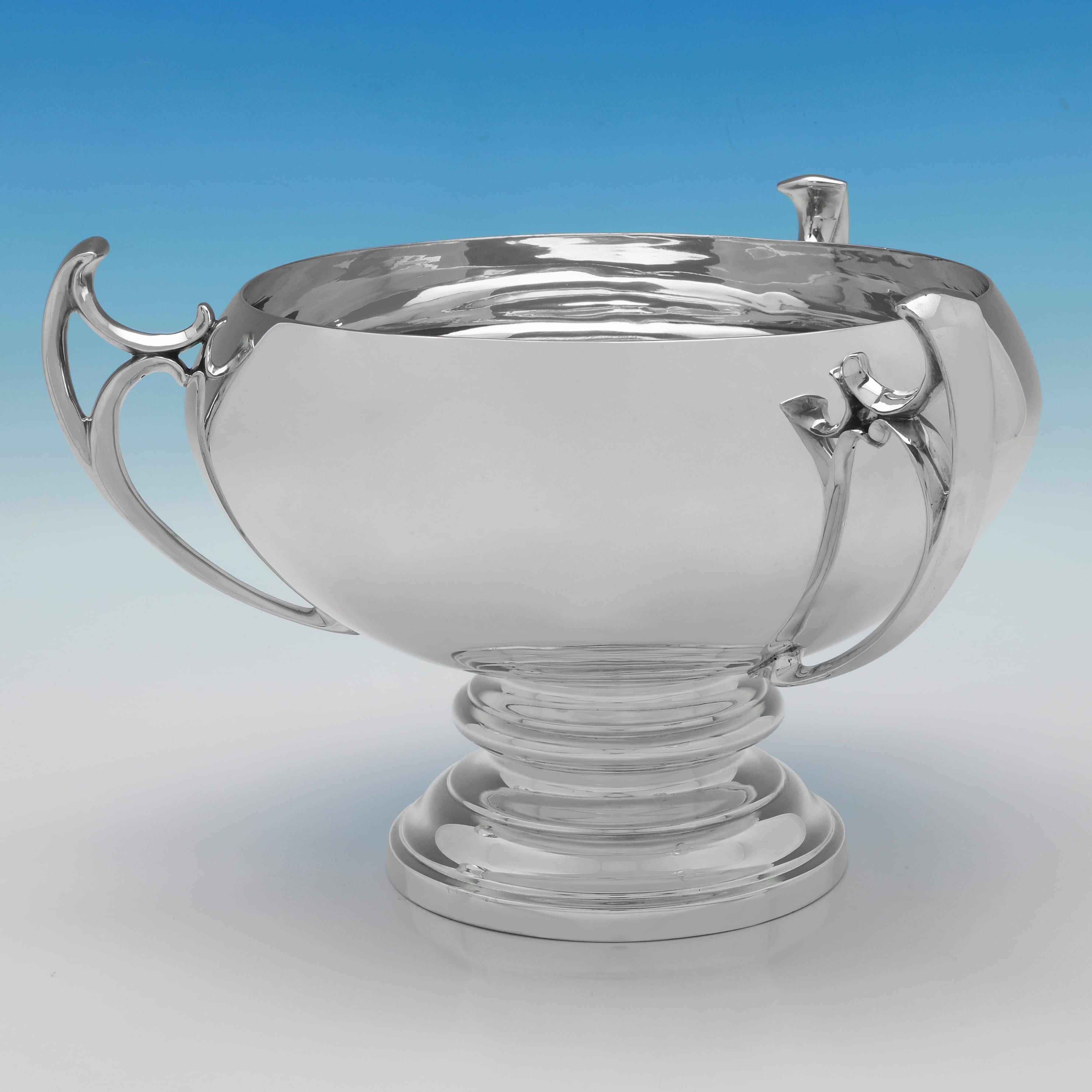 A remarkable Edwardian sterling silver three-handled bowl, hallmarked in London in 1910 by the esteemed Edward Barnard & Sons Ltd. Standing 8 inches (20.5 cm) tall with a diameter of 12 inches (30.5 cm), and weighing an impressive 46.05 troy ounces,