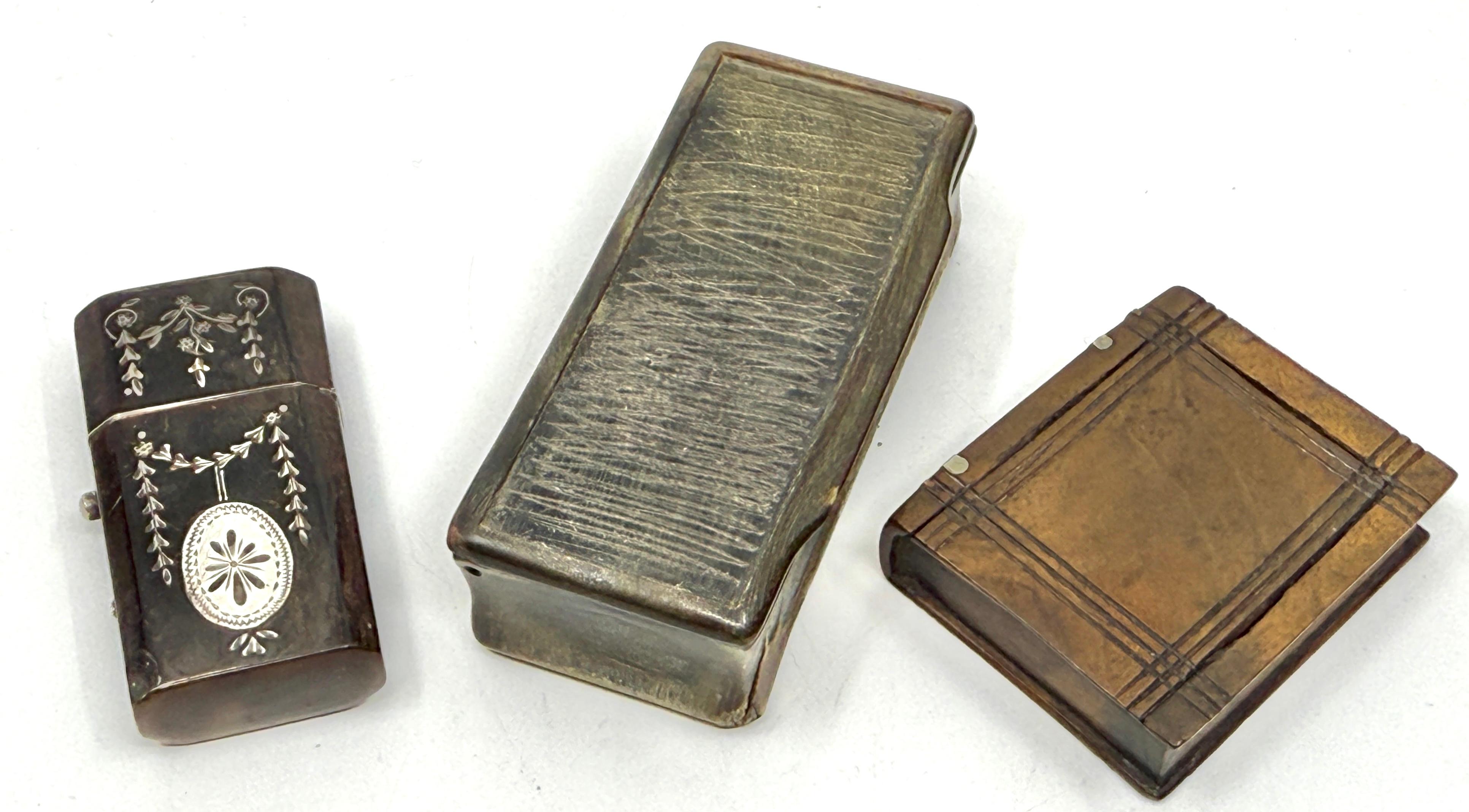 A lovely little group of three Victorian Match safes and little trinket boxes. 
One is horn with silver inlay. It opens with a press of the side lever. Another is  in miniature wood book form with silver inlay on the spine and the front slides out.