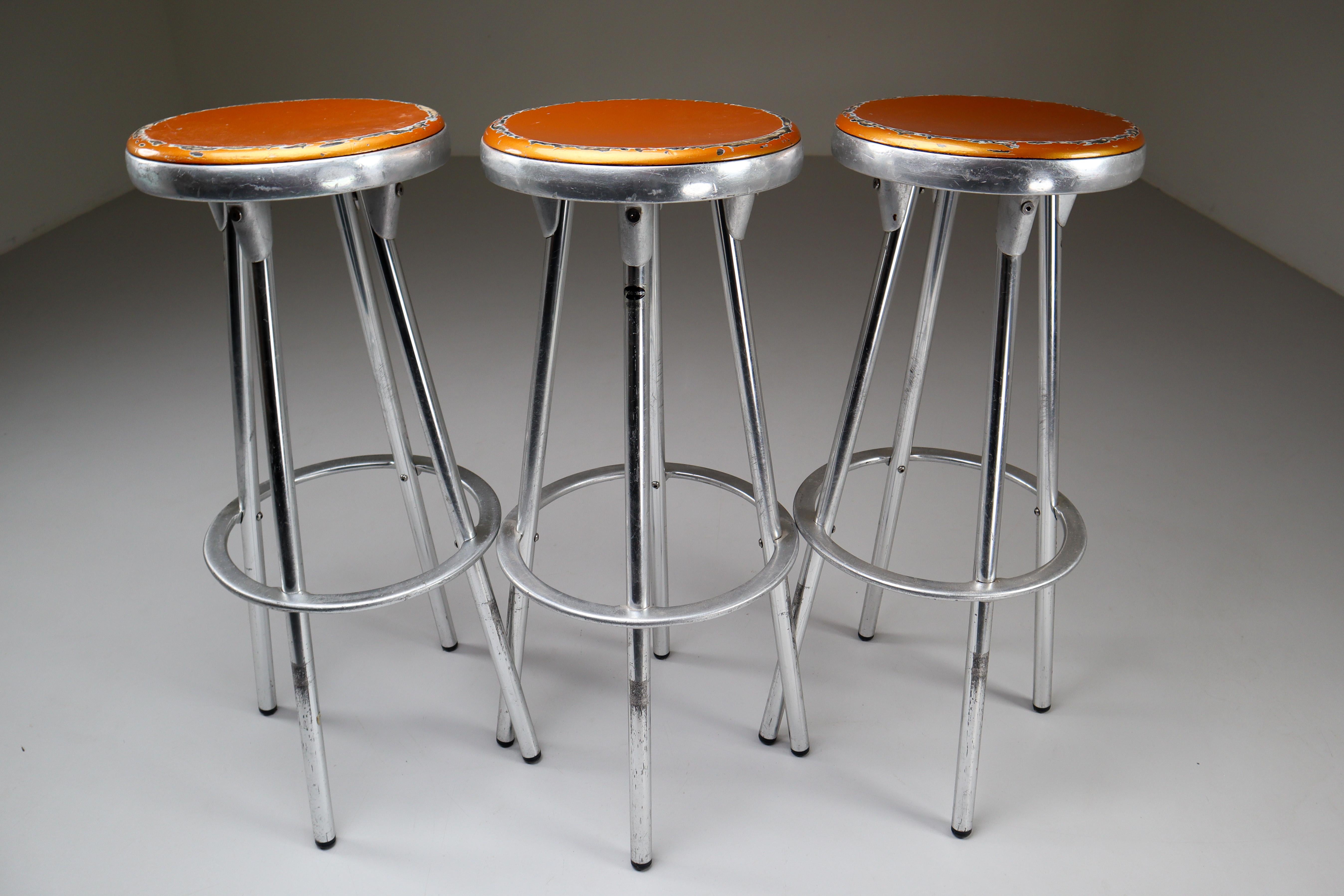 Set of three Industrial bar stools designed by Joan Casas Y Ortinez for Indecasa, Barcelona Spain. This design has the feel of industrial airport counter stool with the added European flair. The stools combine the cast aluminum of the seat and