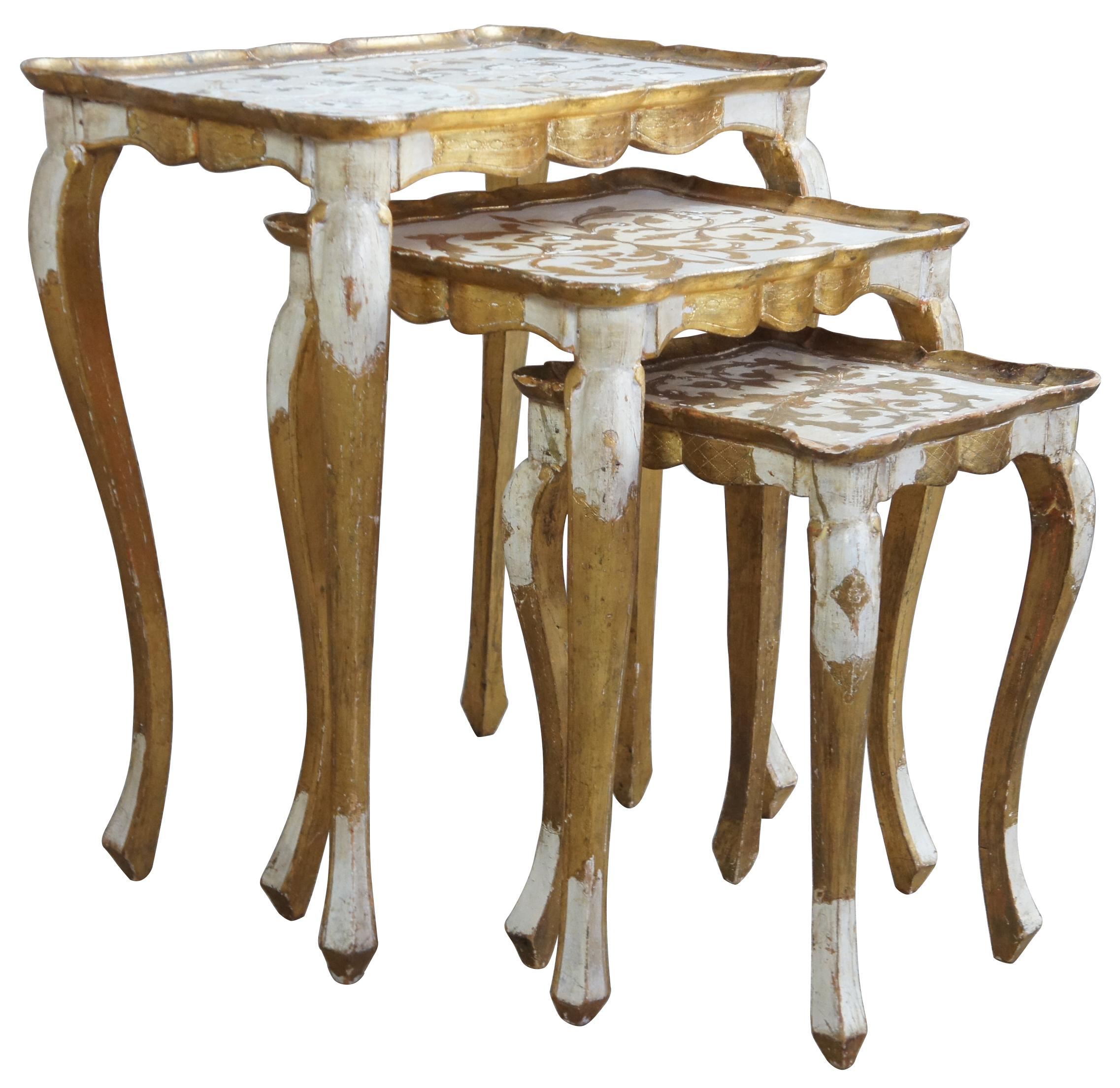 Italian florentine nesting tables. Gold and white with scalloped tops and long cabriole legs.

Measures: Large - 22
