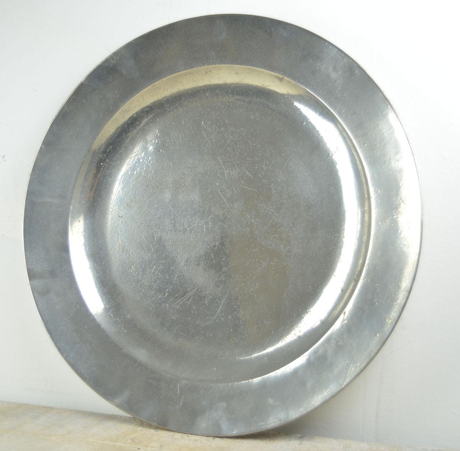 Wonderful highly polished chargers. A lovely distressed industrial look.

The pewter has been polished to its original shine. It was known as the Poor Man's Silver.

The great thing about polished pewter is that it will retain its shine unlike