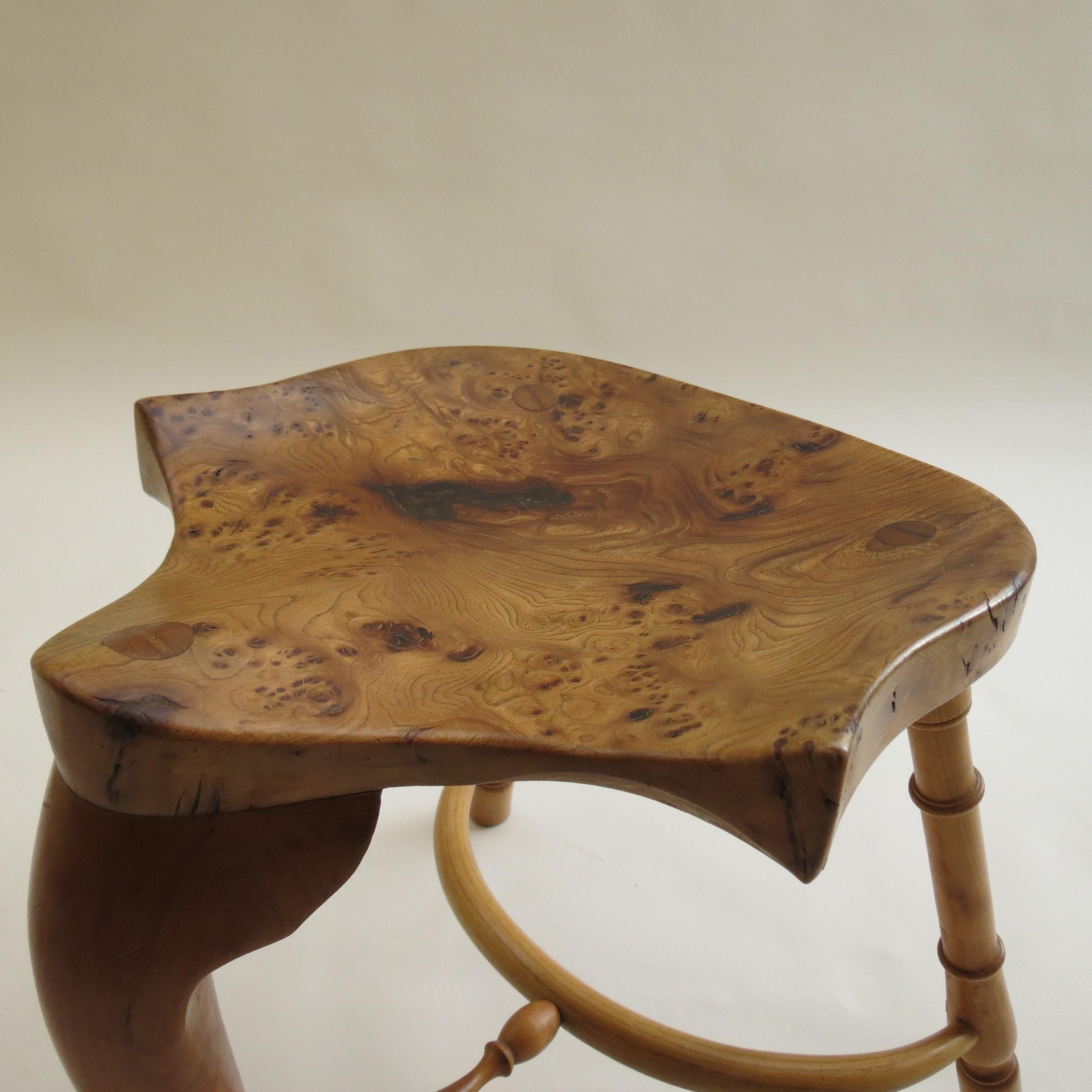 Wonderful, good quality hand produced bespoke stool by Stewart Linford. These date from the 1990s. The stool's wonderfully sculptural seat is made from solid Burr Ash with good figurative detail to the grain, with turned legs made from solid Cherry