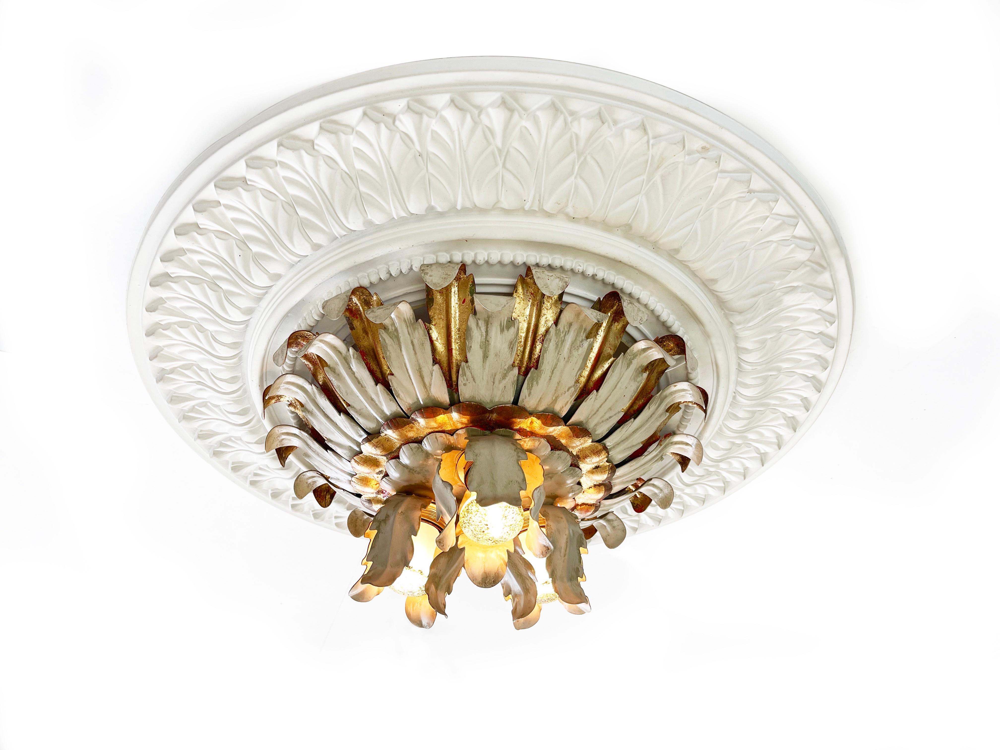 Original 1960s leafed sunburst petal ceiling or wall light by German maker Reindl.
Beautiful and impressive Hollywood Regency style with layered petals of gold & red, and beige greyish colour.
Three lights are held by another layer of metal leaves.
