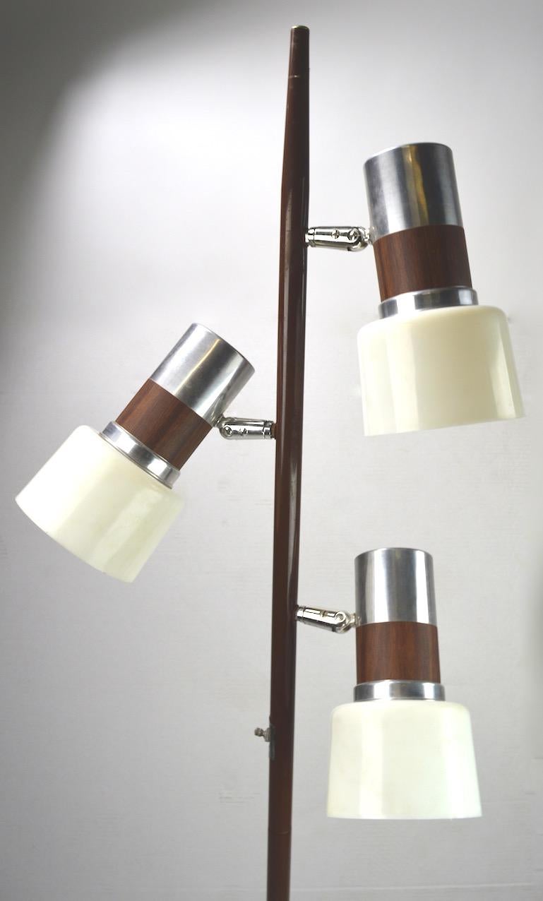 Three light pole lamp with adjustable shades, each shade is aluminum with faux wood trim and white plastic diffusers. Vertical pole is in original brown paint finish, with bright chrome base. Three way on/off switch allows each light to operate